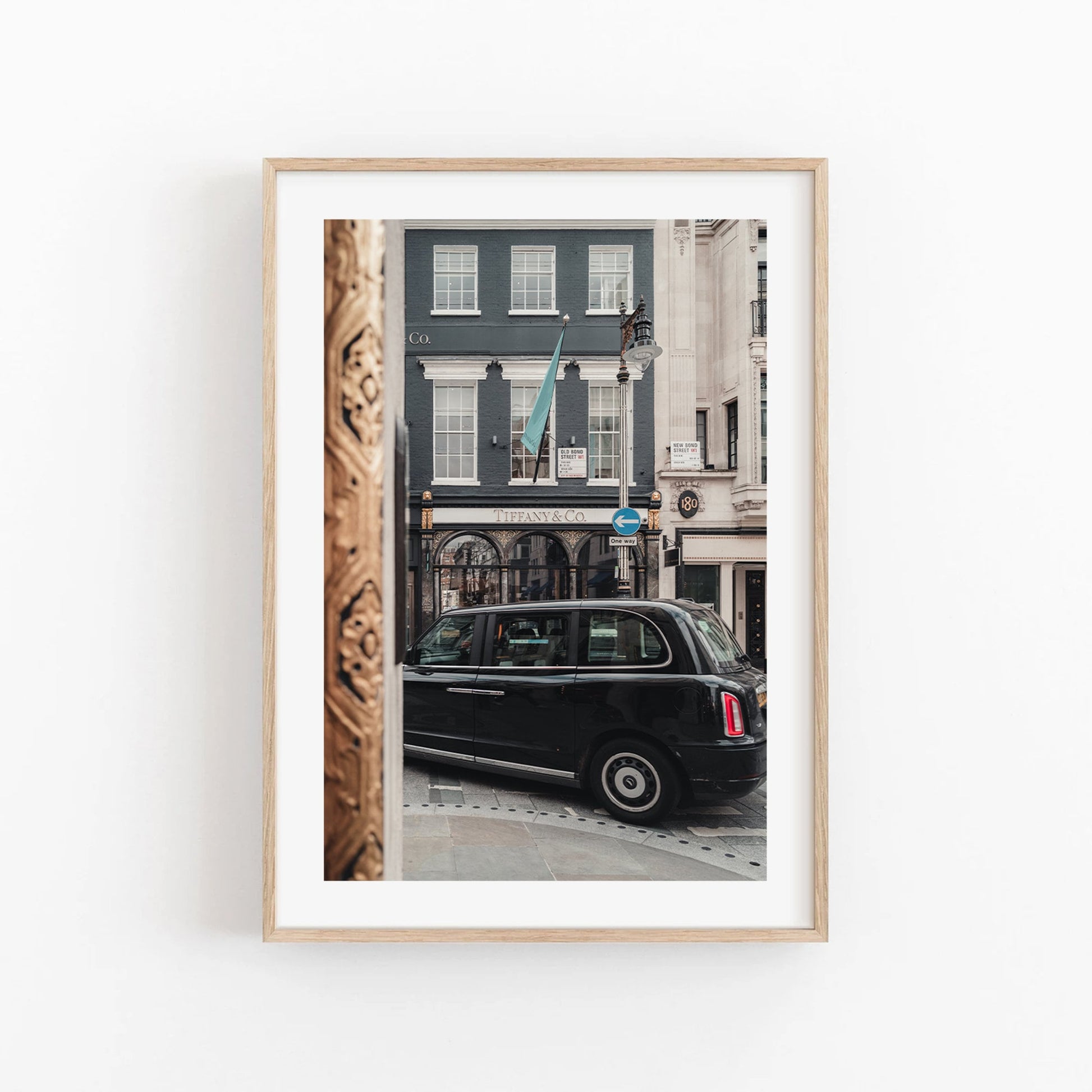 Framed Mayfair Gild photo of a black taxi by a Tiffany & Co. store with a decorative wooden column visible.