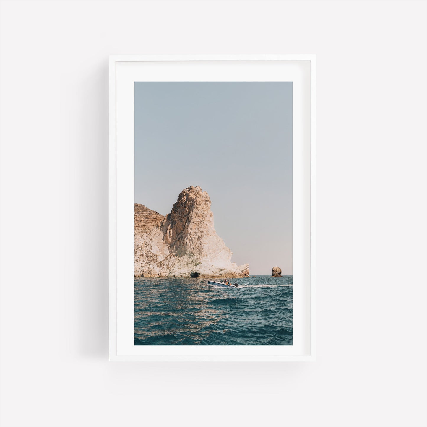 ‘Mediterranean Adventure’—photo of a rocky sea cliff with waves, white-framed against a plain background.