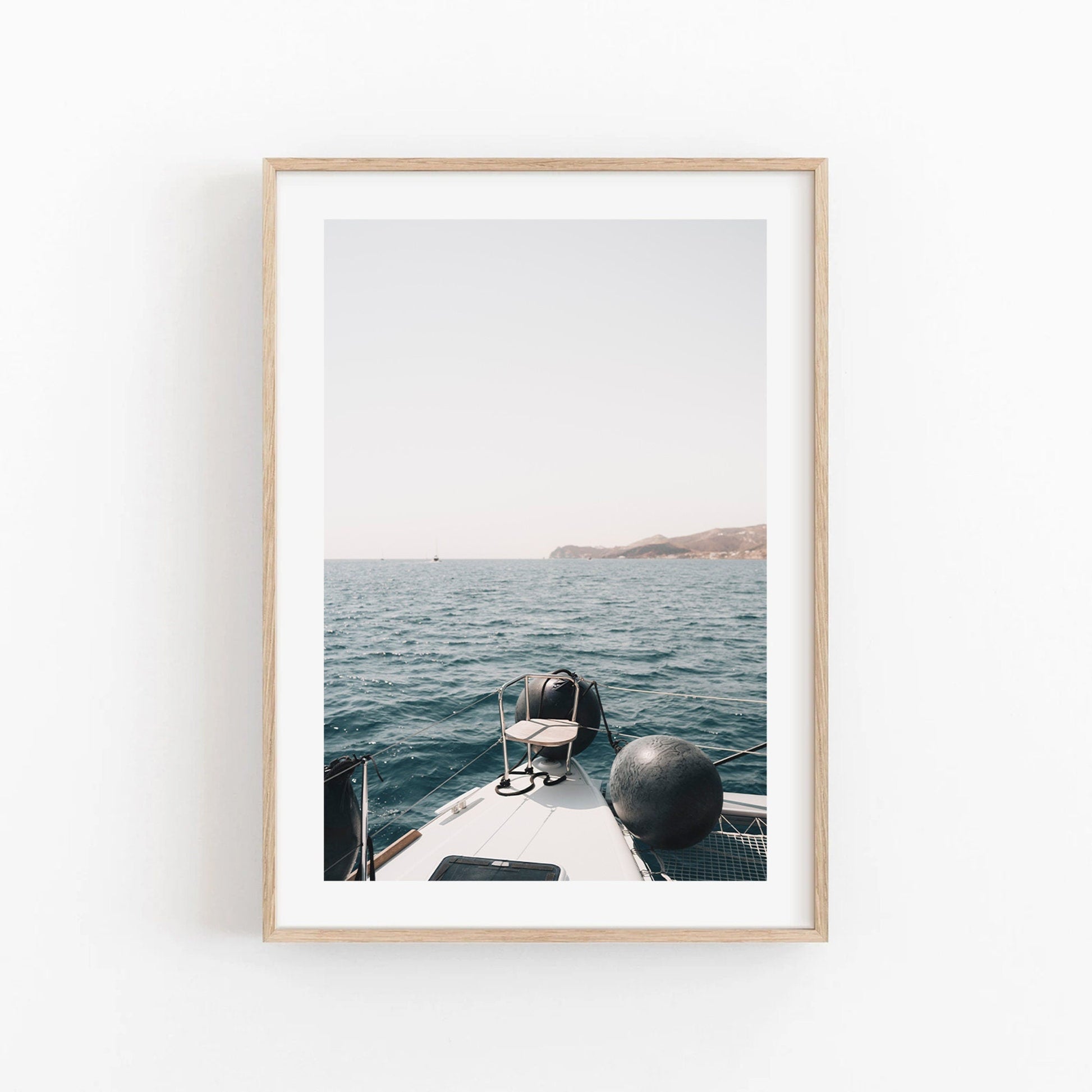 A photo titled Mediterranean Bliss shows a boats bow on calm blue water with distant mountains on the horizon.