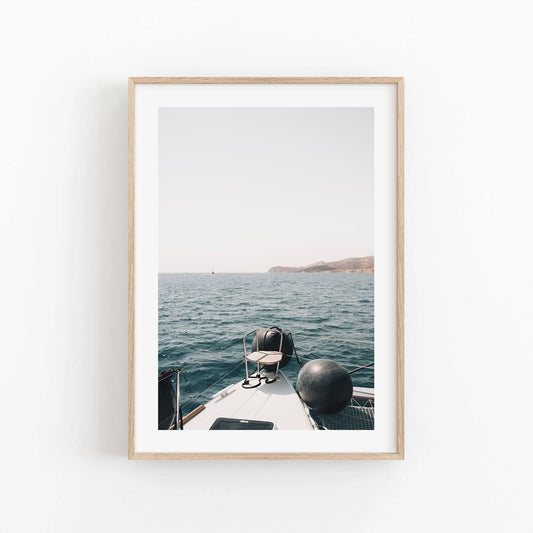 A photo titled Mediterranean Bliss shows a boats bow on calm blue water with distant mountains on the horizon.