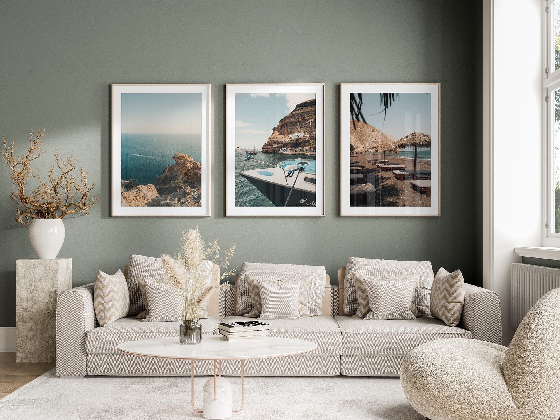 A modern living room with a beige sofa, decorative pillows, and the Mediterranean Coast - Set of 3 on a green wall.