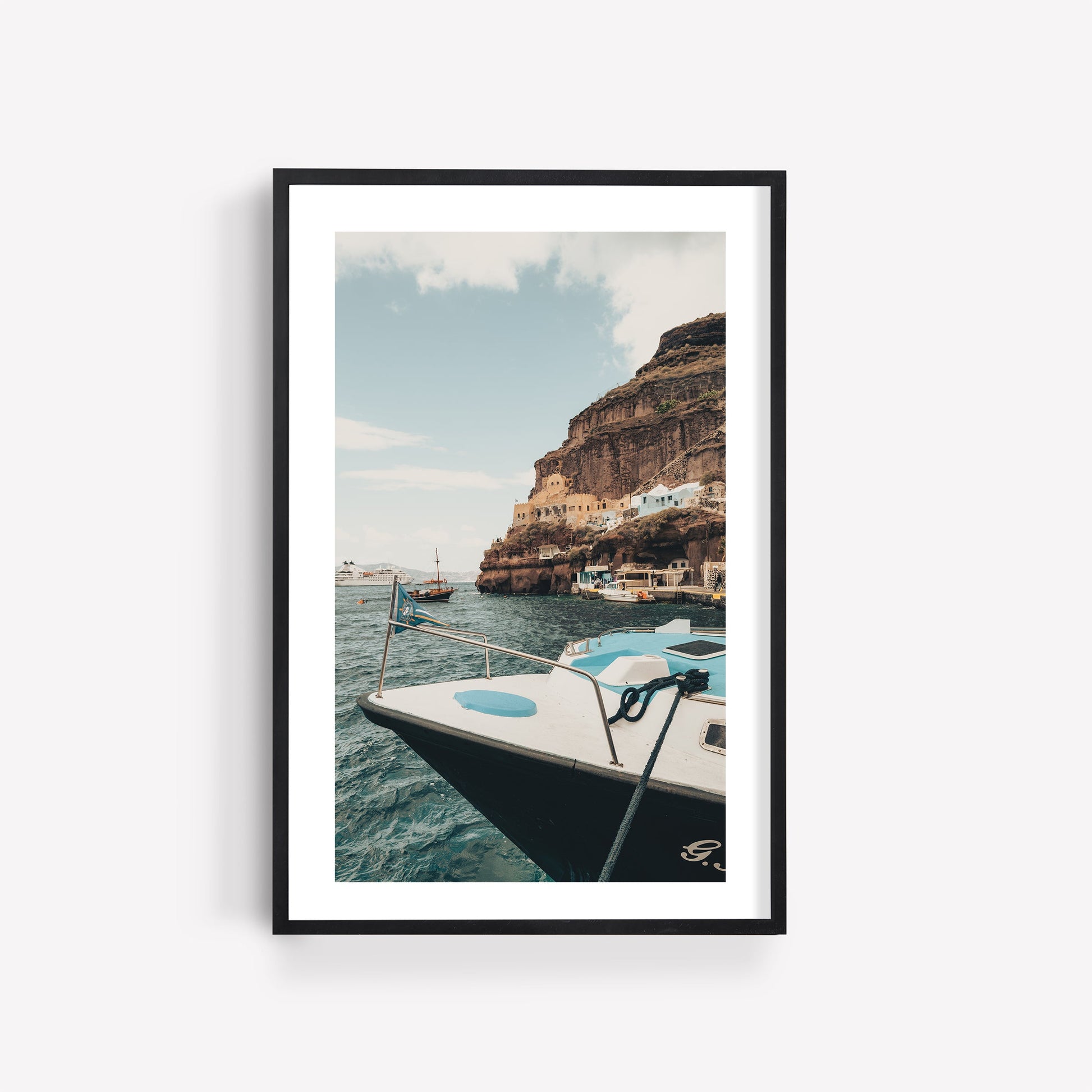 Framed Mediterranean Coast - Set of 3 photos: boats by rocky cliffs and buildings under a partly cloudy sky.