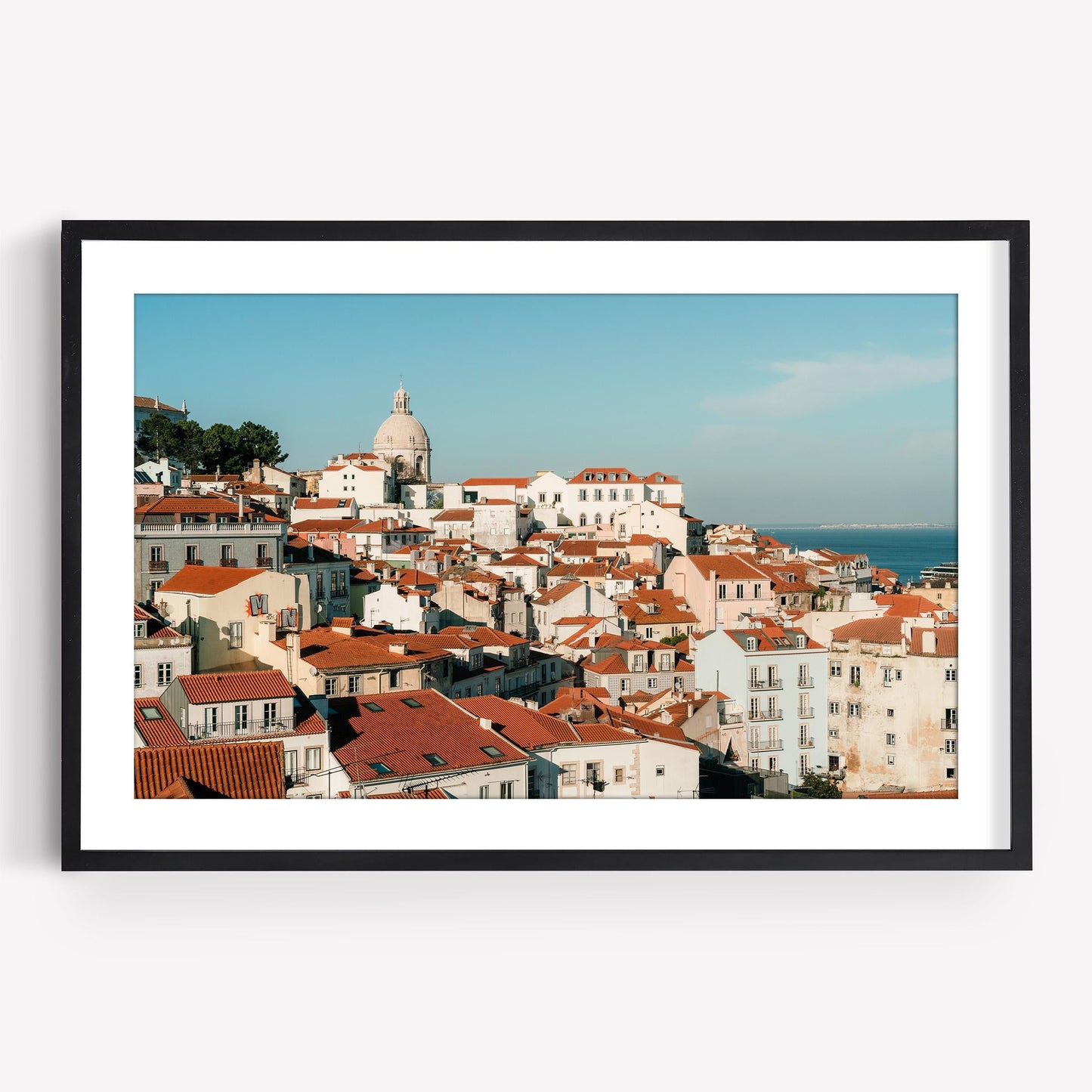 Miradouro: Framed photo of a coastal cityscape with red rooftops, white buildings, and a domed church.