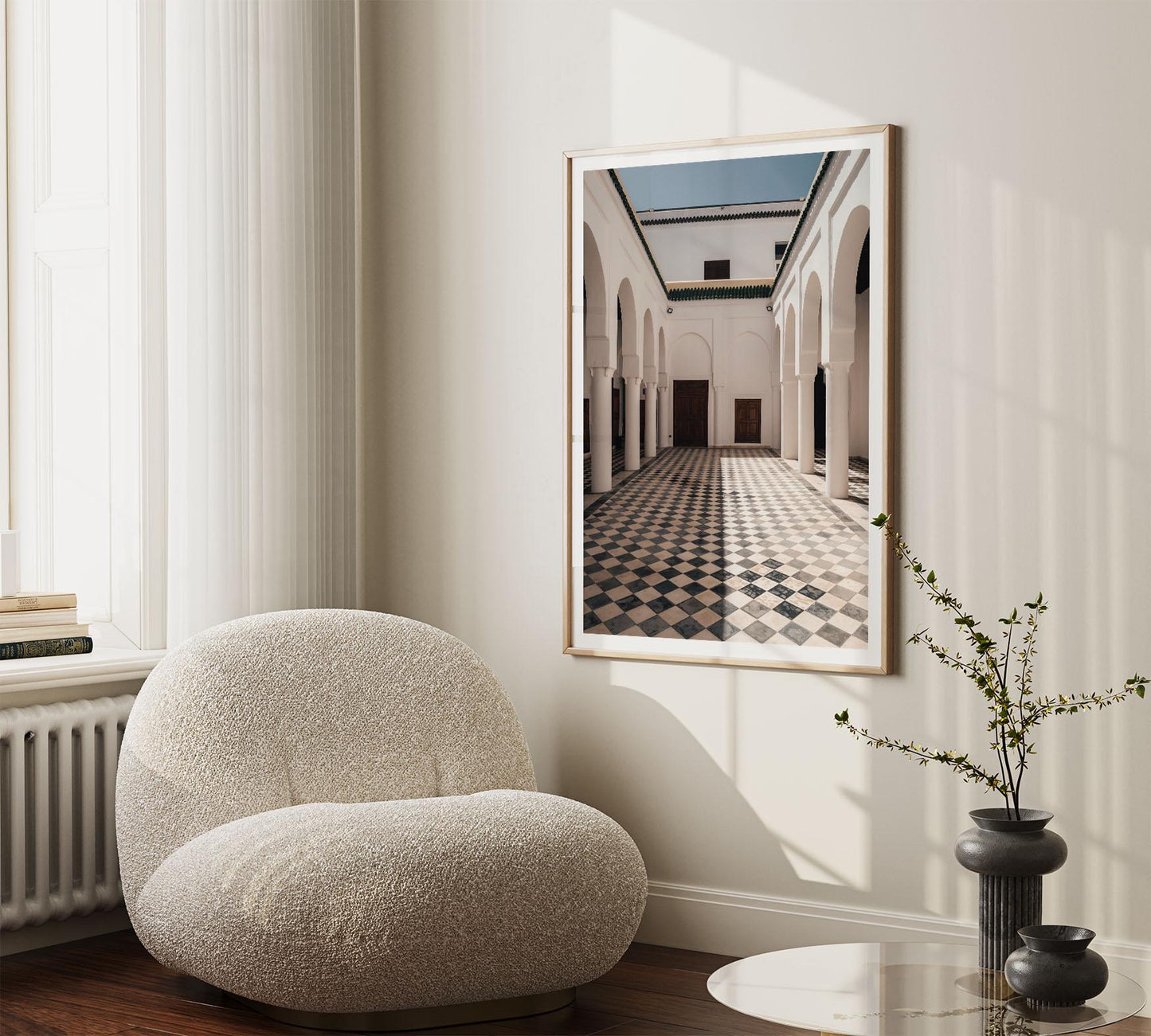 Cozy room with a plush chair, elegant decor, and the large Moroccan Architecture I photo framed on the wall.
