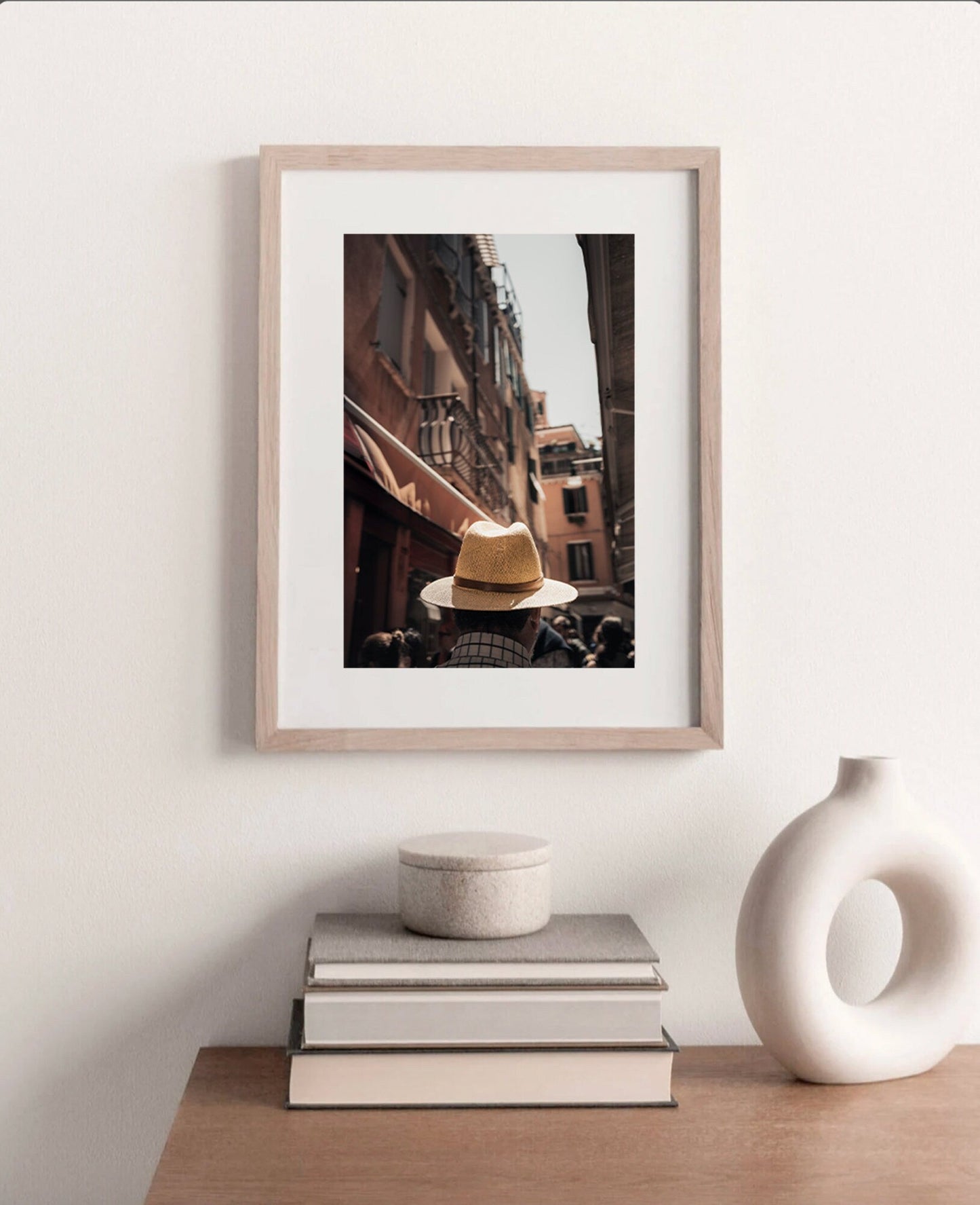 Mystery Man framed photo of a person in a straw hat on an urban-themed minimalist shelf.