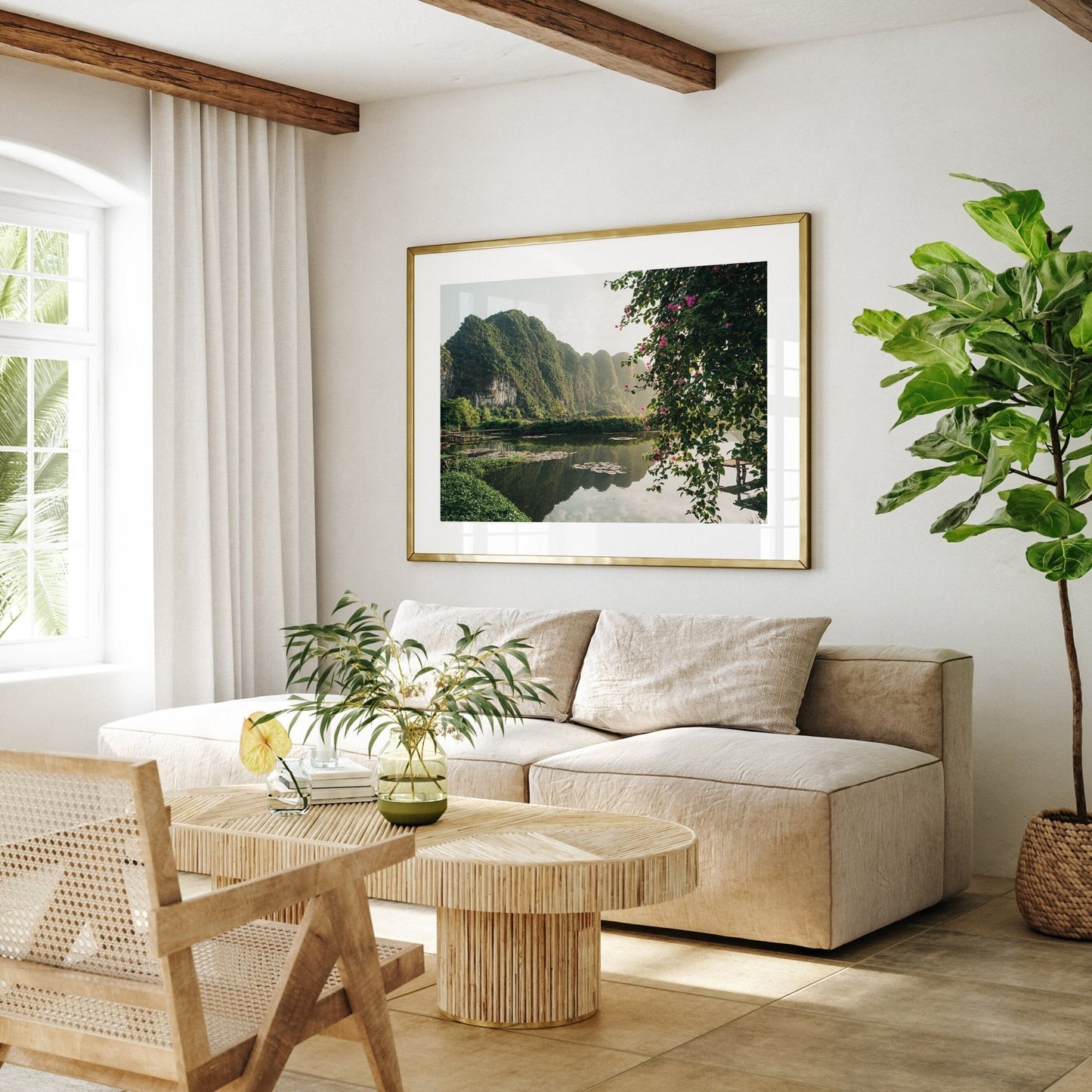 Cozy living room with the Ninh Binh Serenity artwork on the wall, beige sofa, wooden table, and plotted plants.