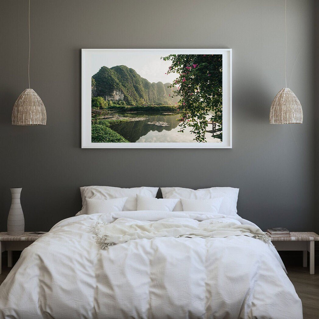 A serene bedroom featuring the Ninh Binh Serenity landscape artwork, a cozy bed, and pendant lights.
