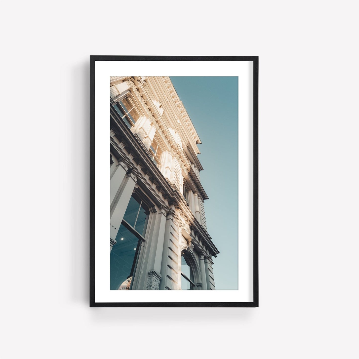 Framed photo of Noho I, a classic building with ornate architecture against a clear blue sky.