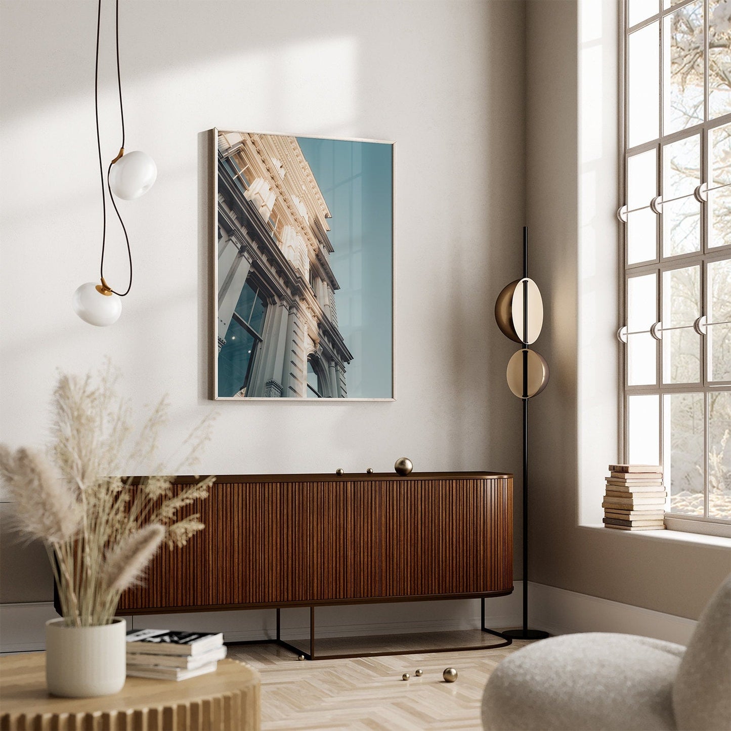 A stylish living room with Noho I decor, a photo of architecture, and large windows letting in natural light.