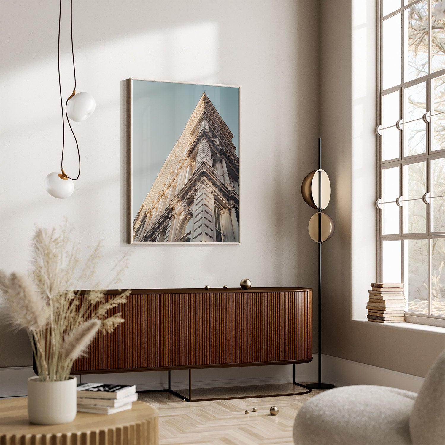Modern living room with Noho II photo, brown sideboard, tall lamp, and large window bringing in natural light.