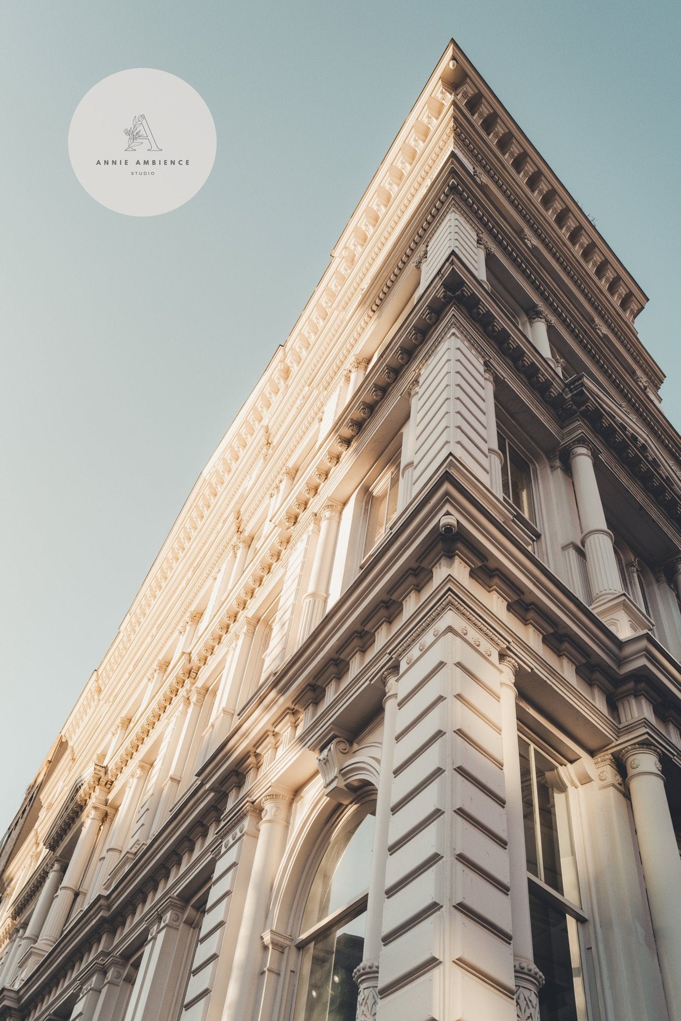The Noho II showcases classic architecture with ornate details, captured from a low angle against a clear blue sky.