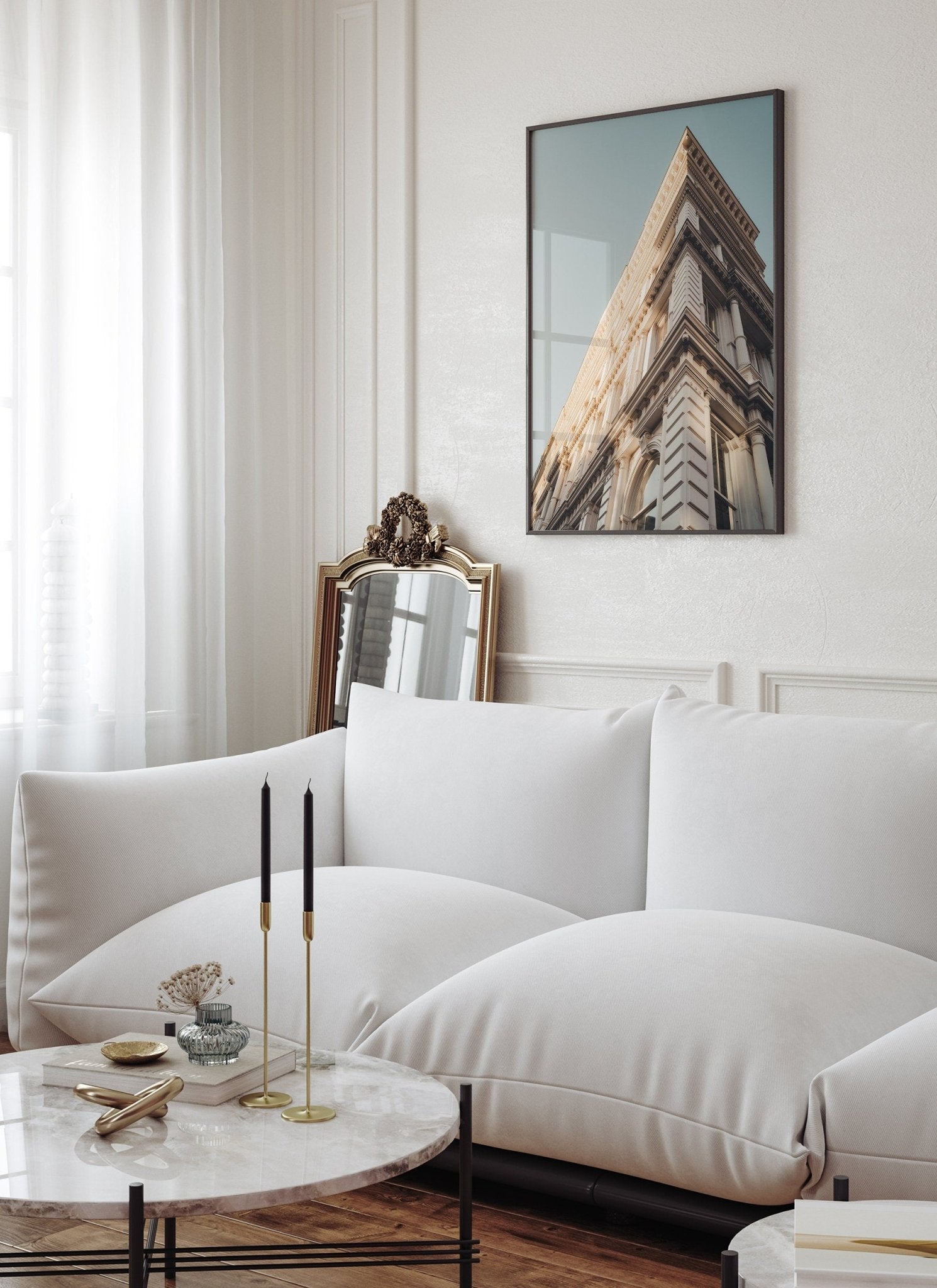 Minimalist living room with Noho II sofa, a mirror, building photo on the wall, and candles on the table.