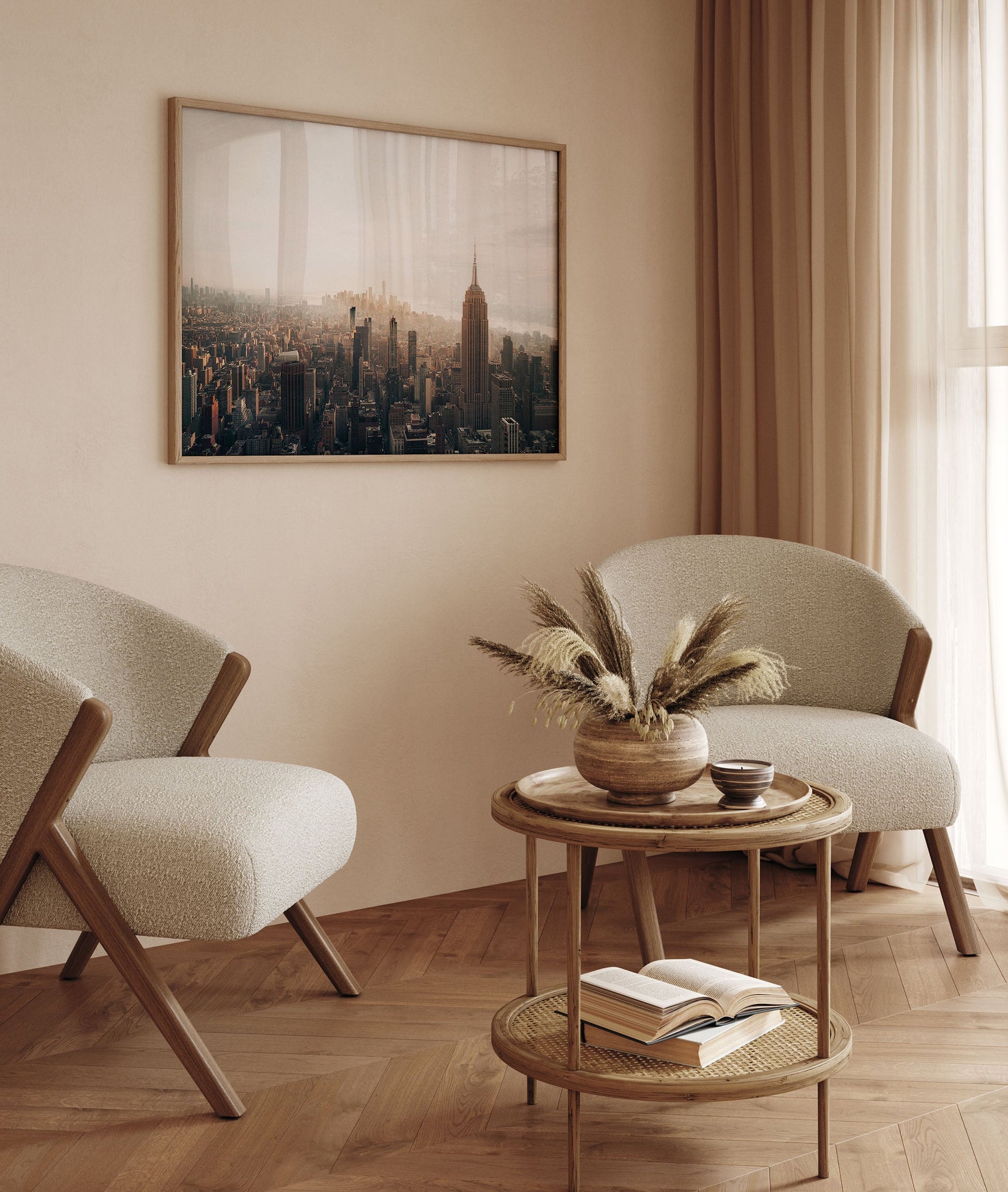 Minimalist living room with two beige chairs, a round table, and the NYC Skyline Black and White print on the wall.