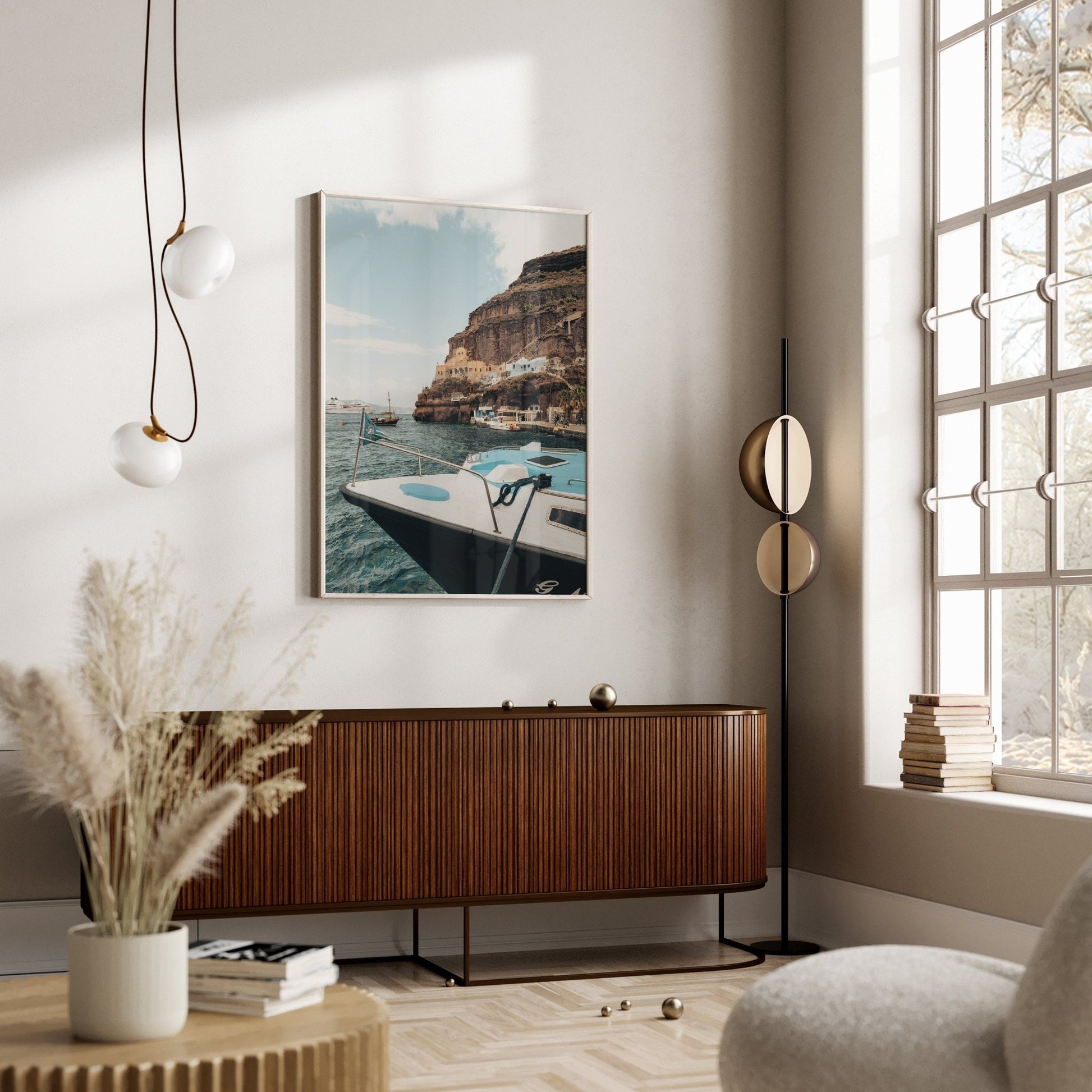 Minimalist living room with modern decor, featuring the Old Port Fira, pendant lights, and a wooden sideboard.