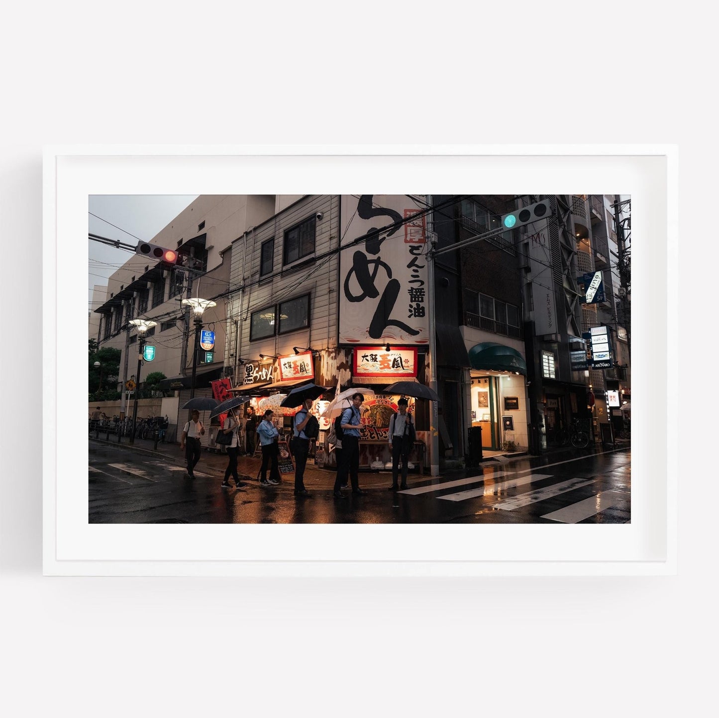 A scene of people with Osaka Drizzle umbrellas outside a ramen shop in the city, bright signs lighting up the wet pavement.