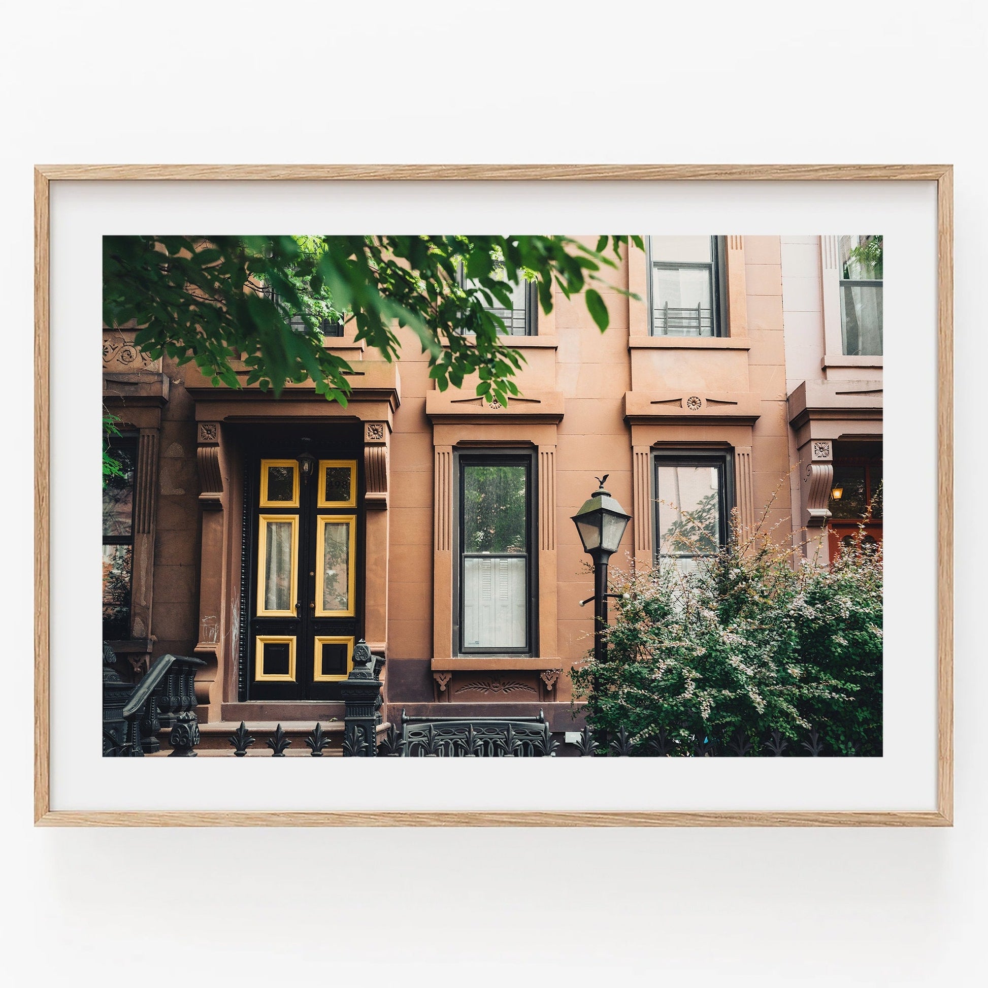 Framed photo Park Slope: Brownstone facade with a yellow door, lamppost, and greenery.