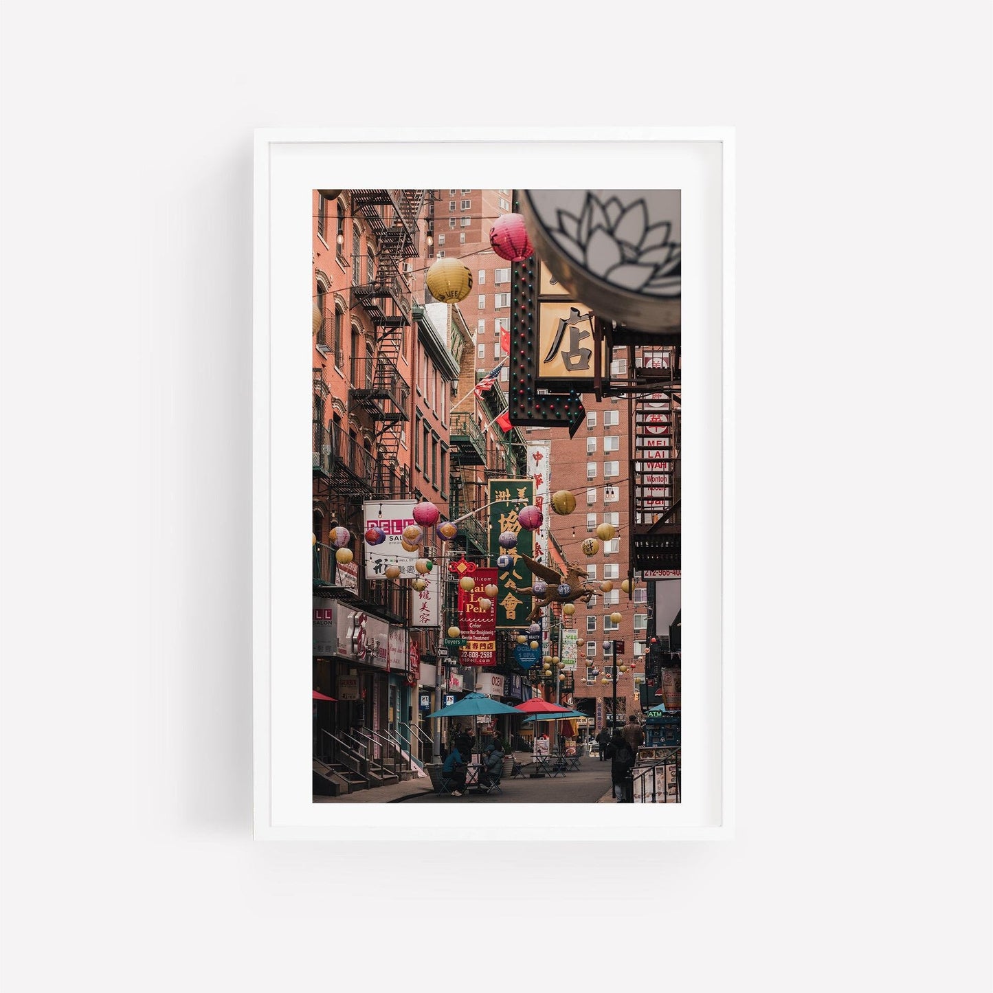 Pell Street: A bustling urban scene with colorful lanterns and multilingual signs.