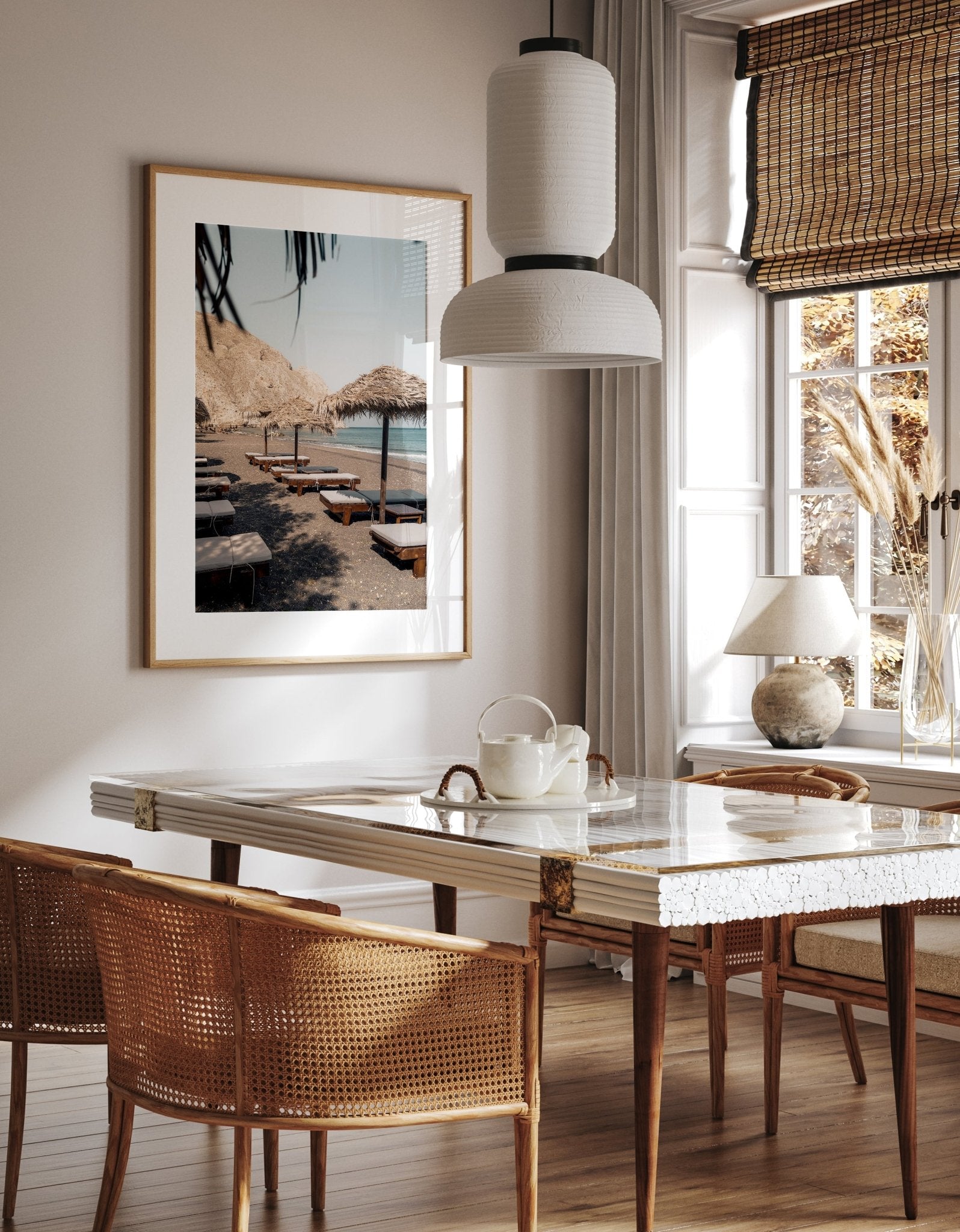 Cozy dining room with Perissa Umbrellas, wicker chairs, and a beach photo. Sunlight streams through a large window.