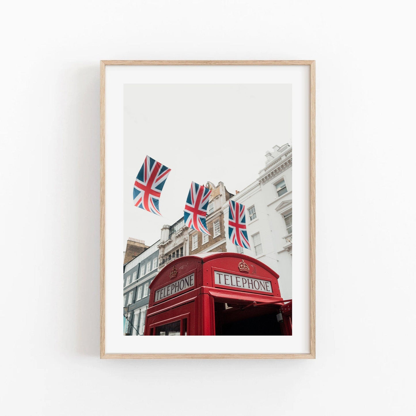Framed photo Red Booth shows a UK telephone kiosk with Union Jack flags and historic buildings in the backdrop.