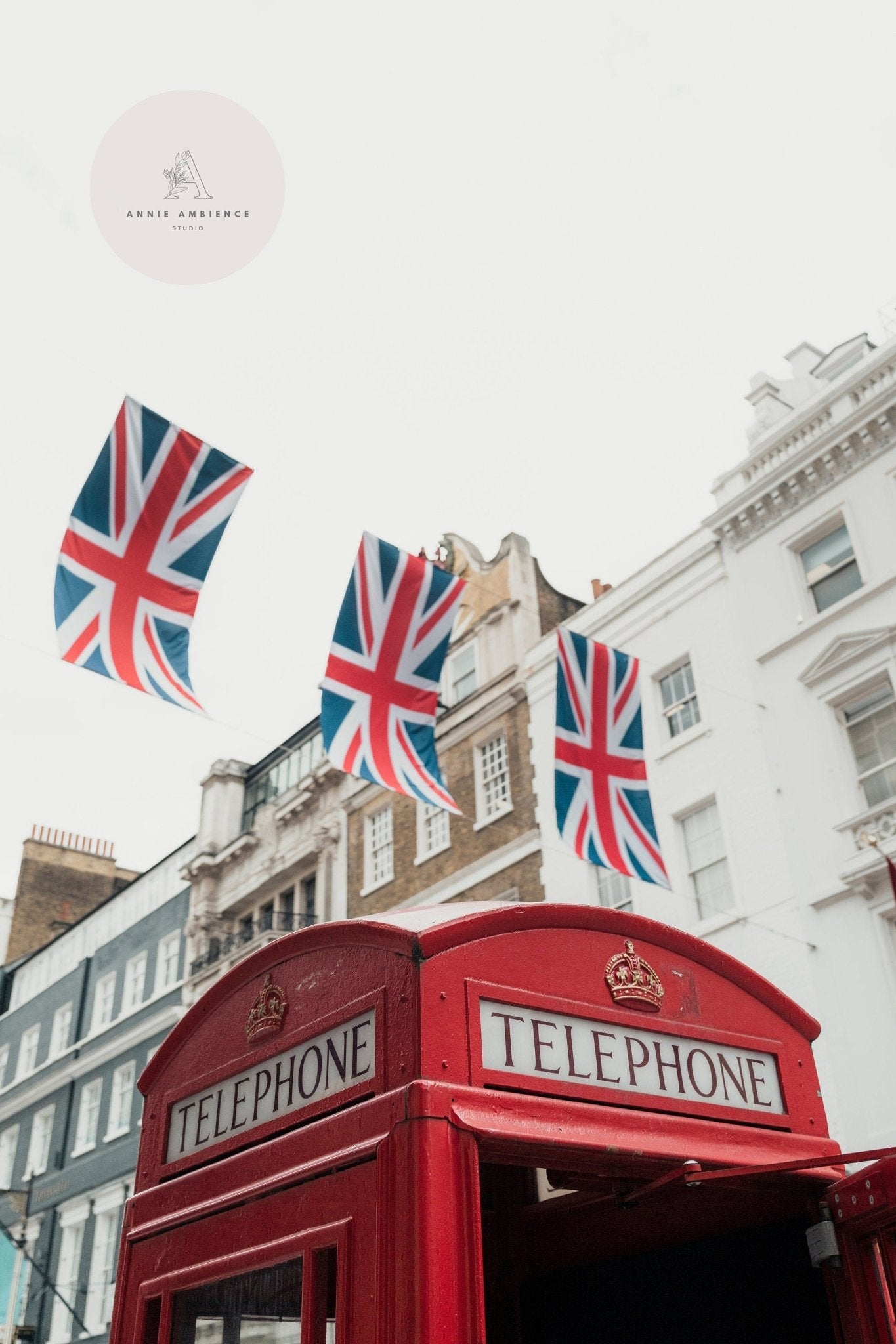 Red Booth and Union Jack flags on a street with white buildings in the background.