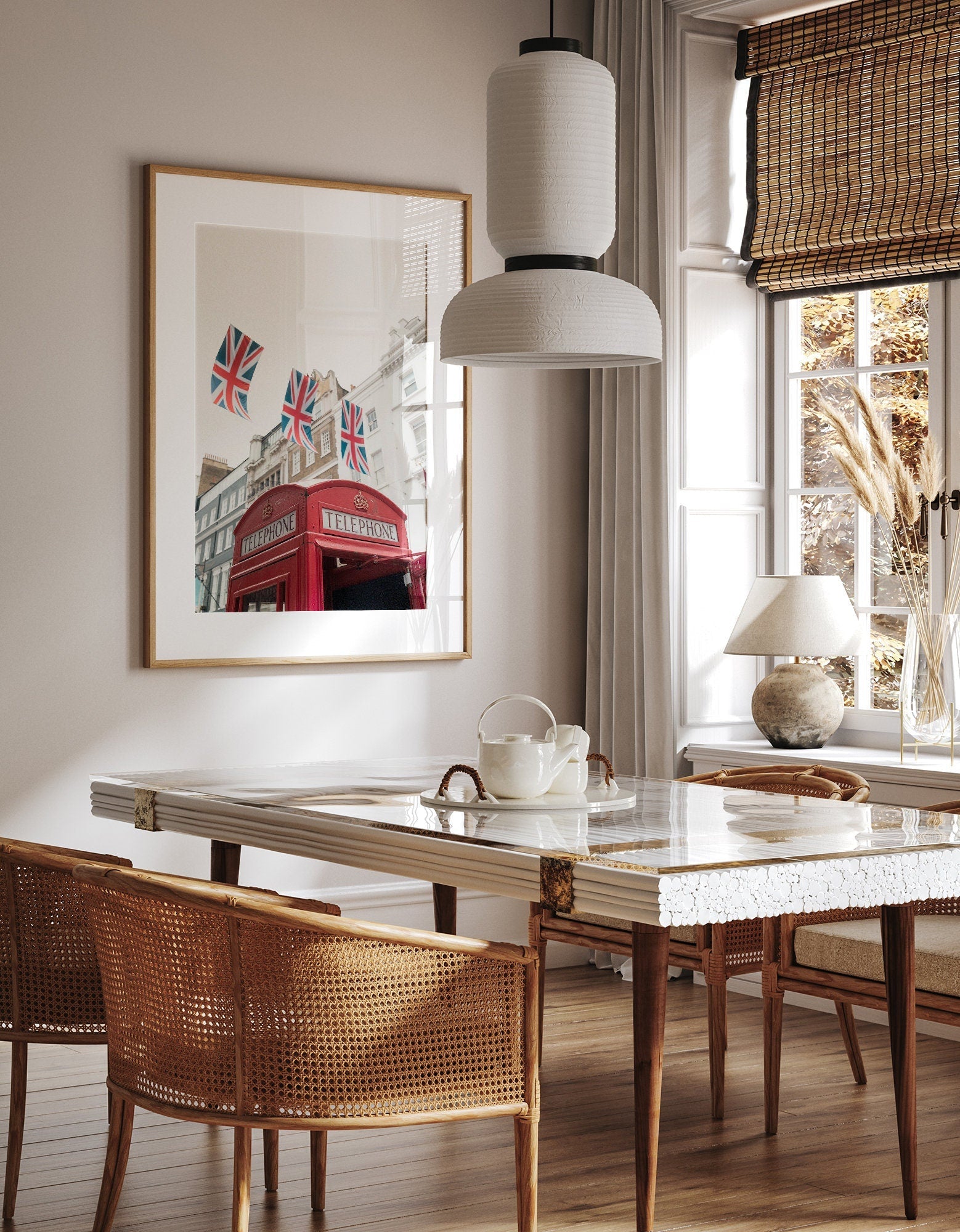 Stylish dining room featuring a Red Booth with a marble table, wicker chairs, and British-themed wall art.