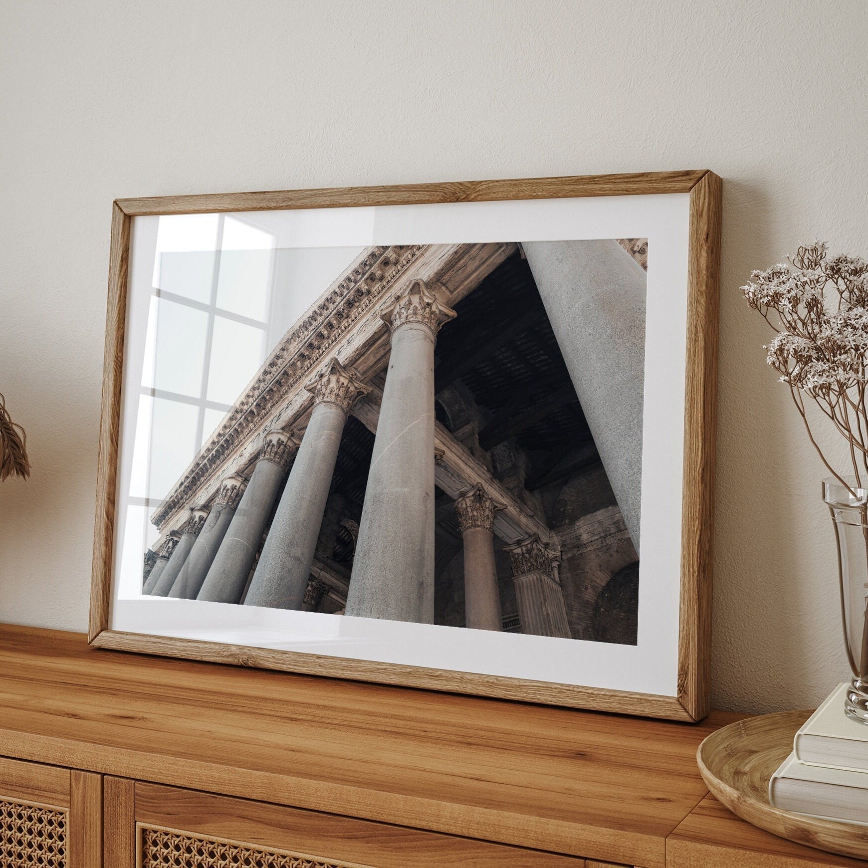 Roman Pantheon II photo displayed on a wooden dresser with dried flowers.
