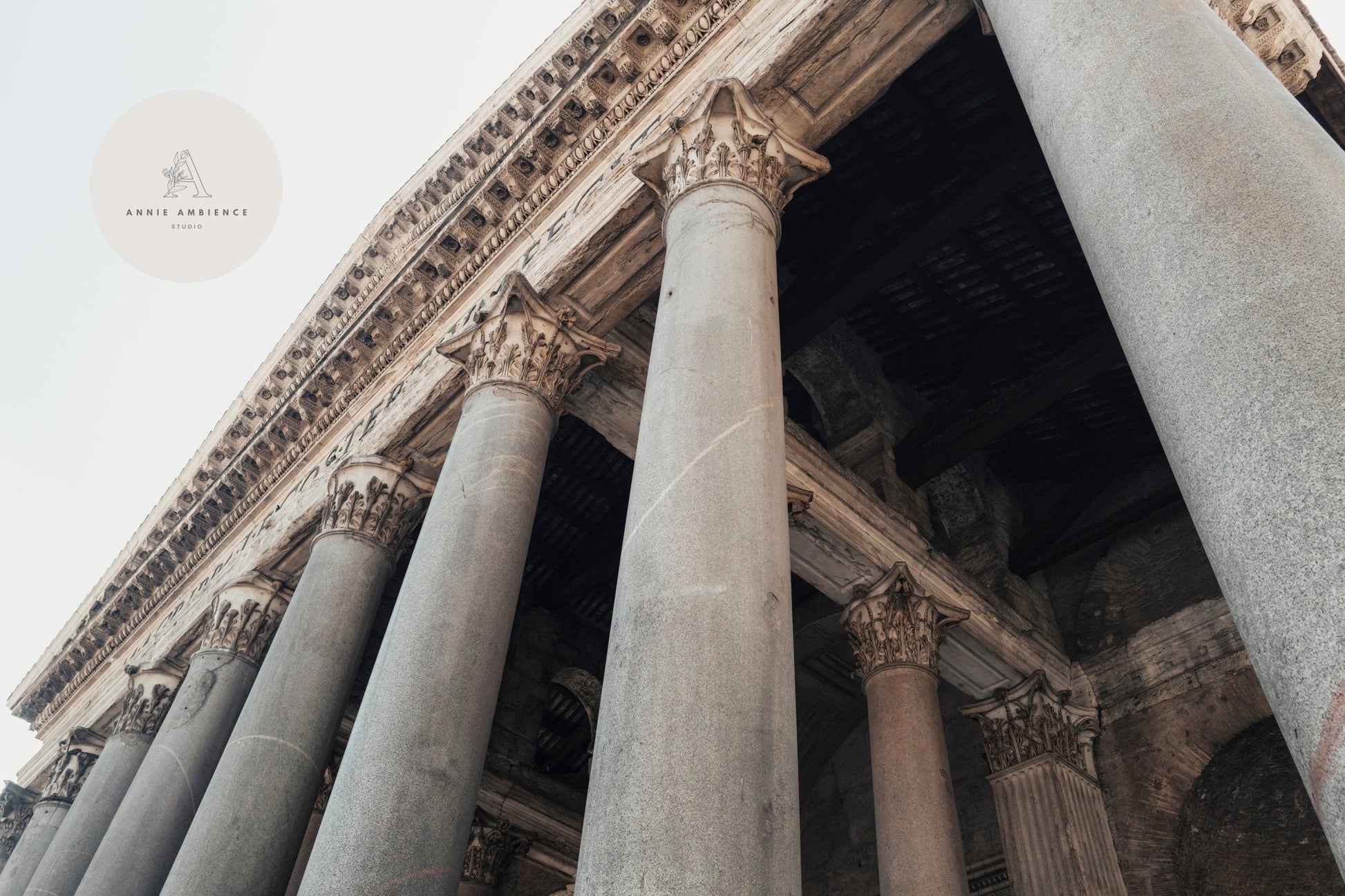 Low-angle view of Roman Pantheon IIs ancient stone columns with intricate carvings.