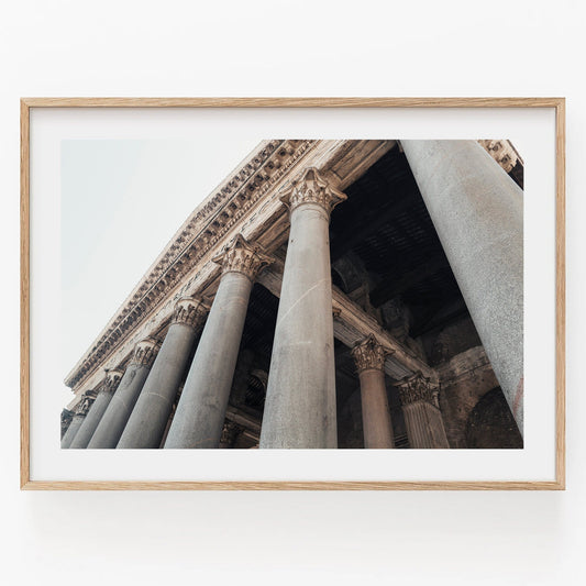 Framed photo of the Roman Pantheon II captured from a low angle, showcasing tall stone columns and intricate details.