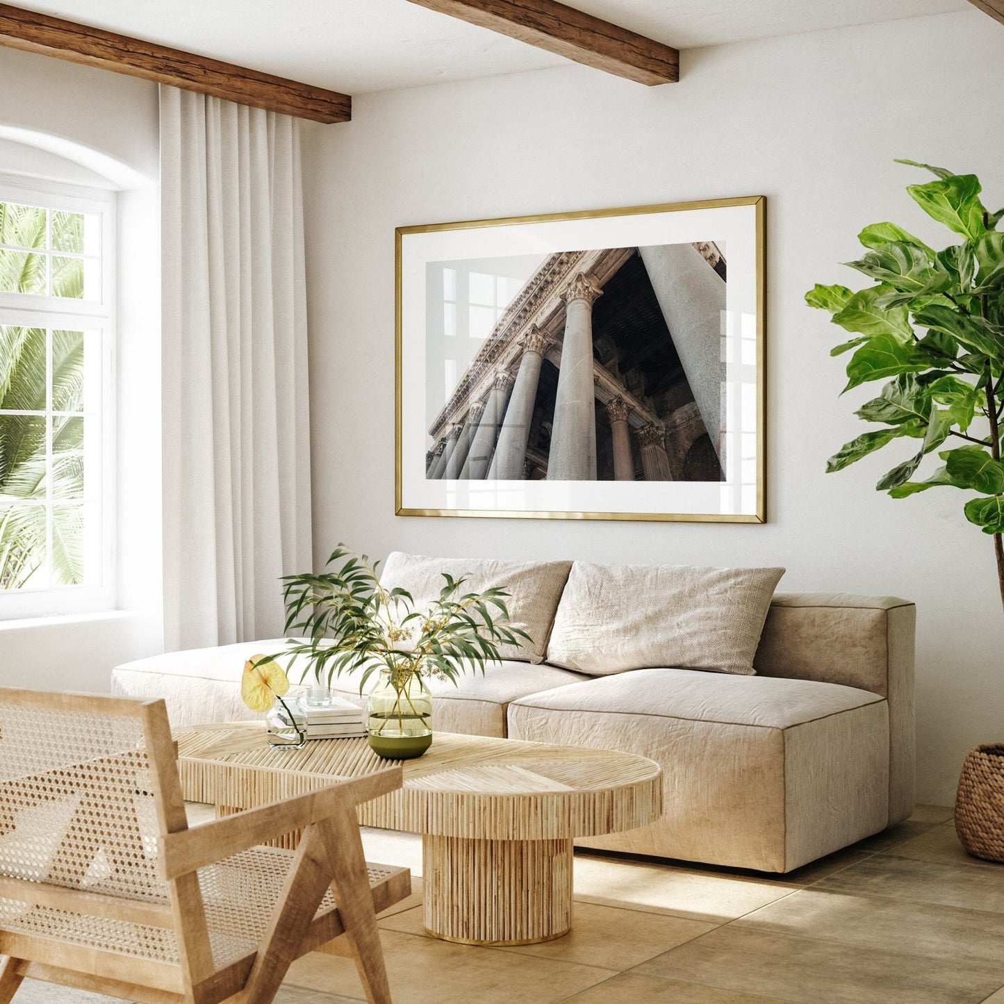 Minimalist living room with a beige sofa, wooden table, plants, and the Roman Pantheon II photo framed on the wall.