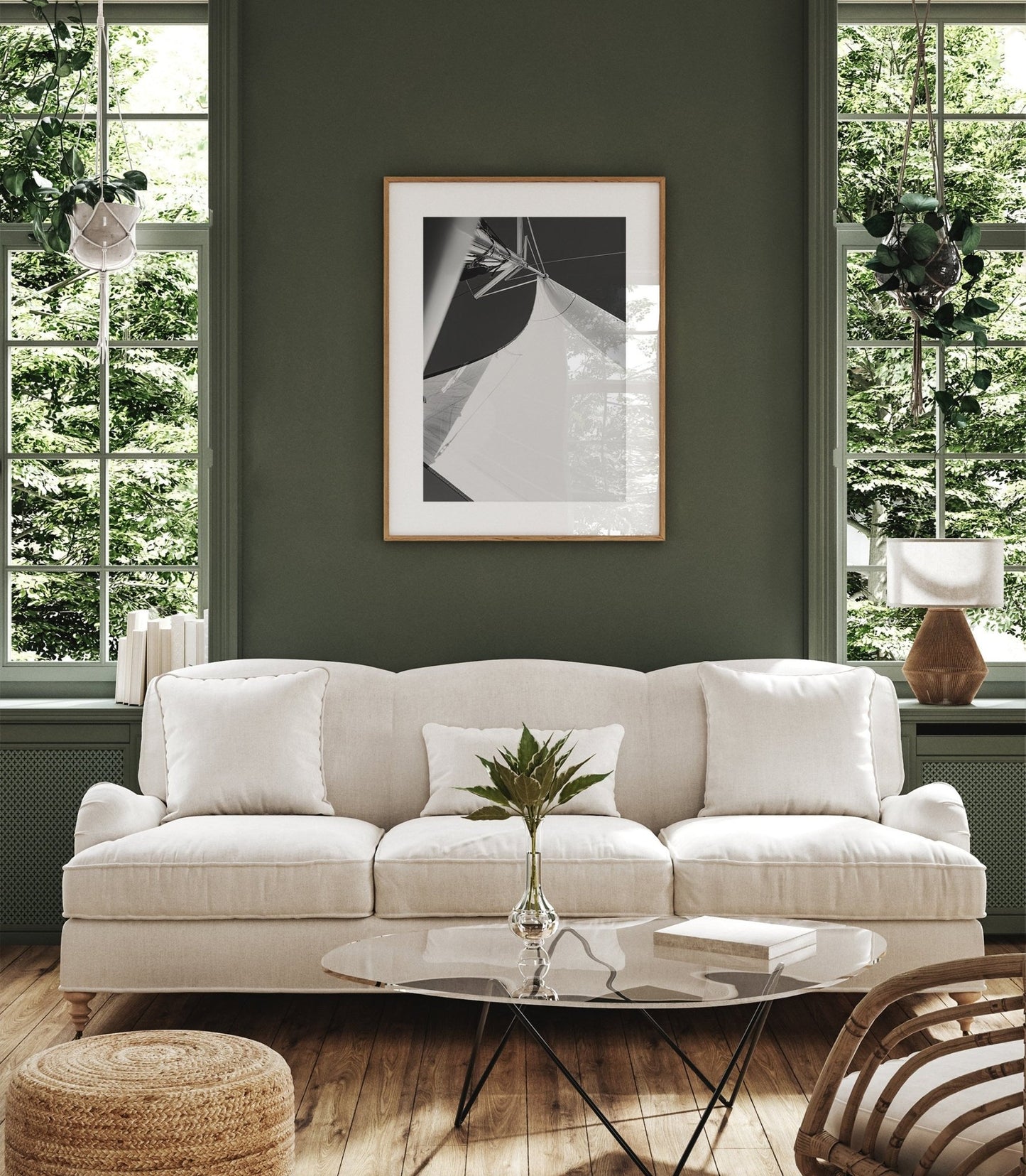 Elegant living room with a Sailing Bliss II sofa, glass coffee table, potted plants in front of large windows and green walls.