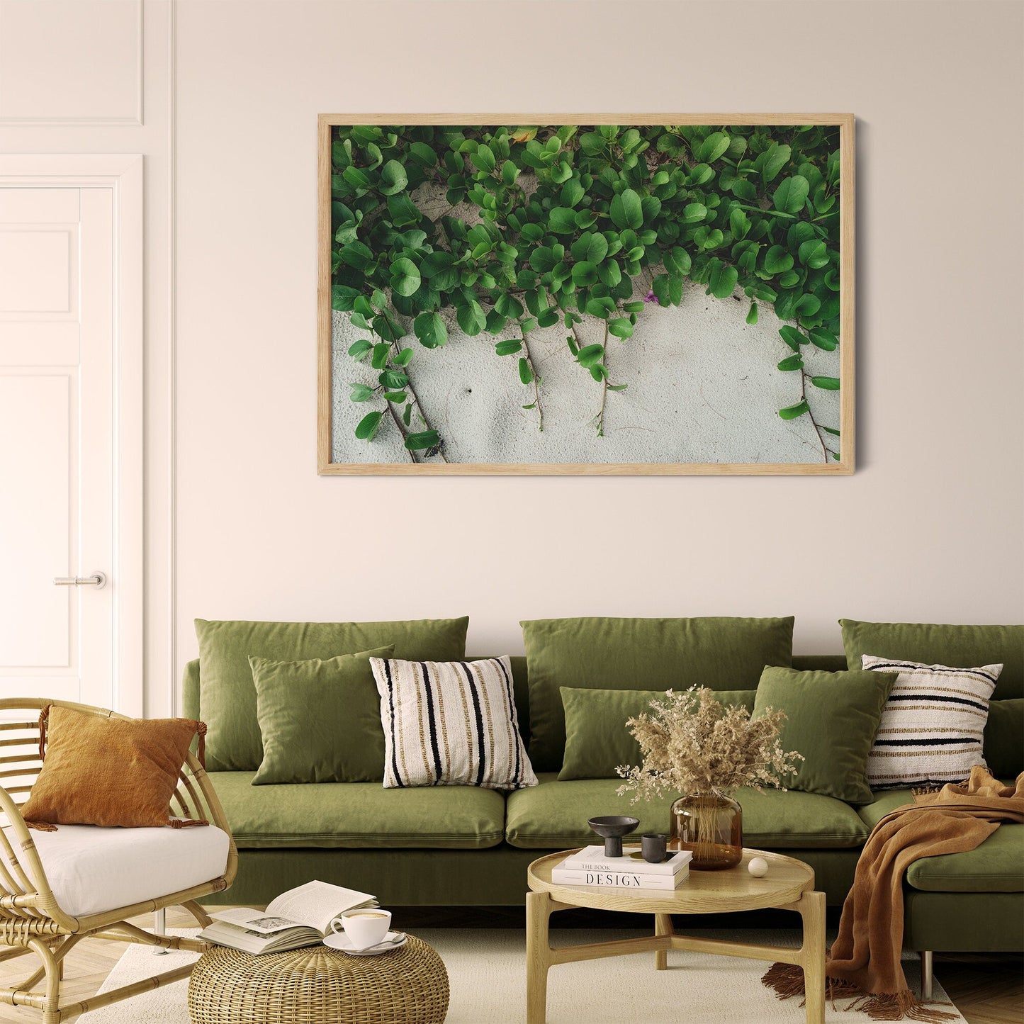 A living room with a green sofa, striped cushions, wooden furniture, and the Sandy Garden I artwork on the wall.