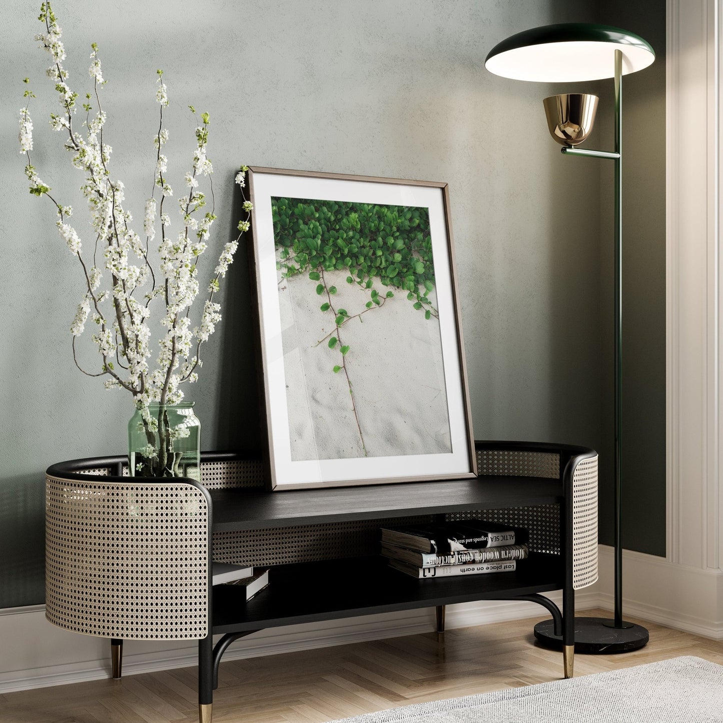 A modern corner with a floor lamp, Sandy Garden II print, white flower vase, curved table, on a wooden floor.