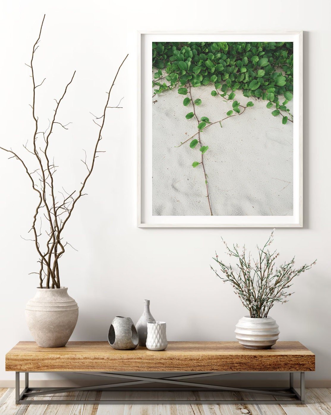 Modern decor featuring the Sandy Garden II wooden table, vases, and a framed plant photo on a white wall.