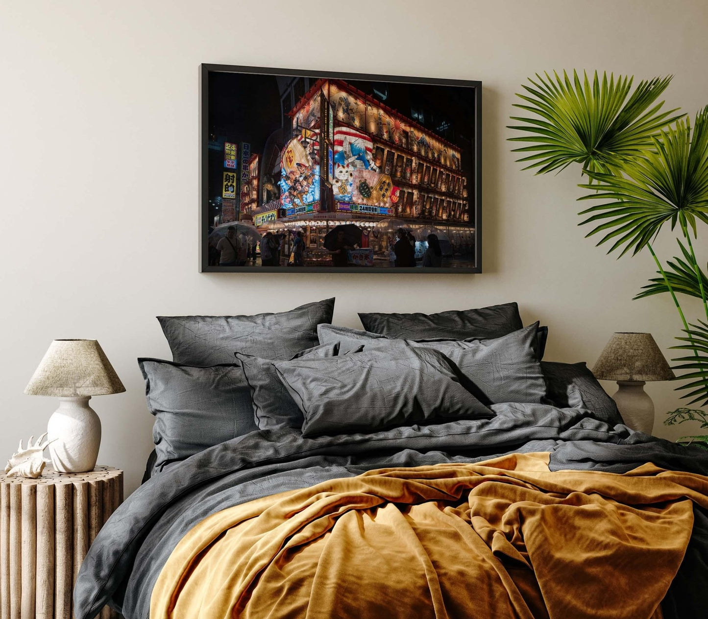 Stylish bedroom with gray bedding, gold accents, plants, and framed cityscape art Shinsekai At Night above the bed.