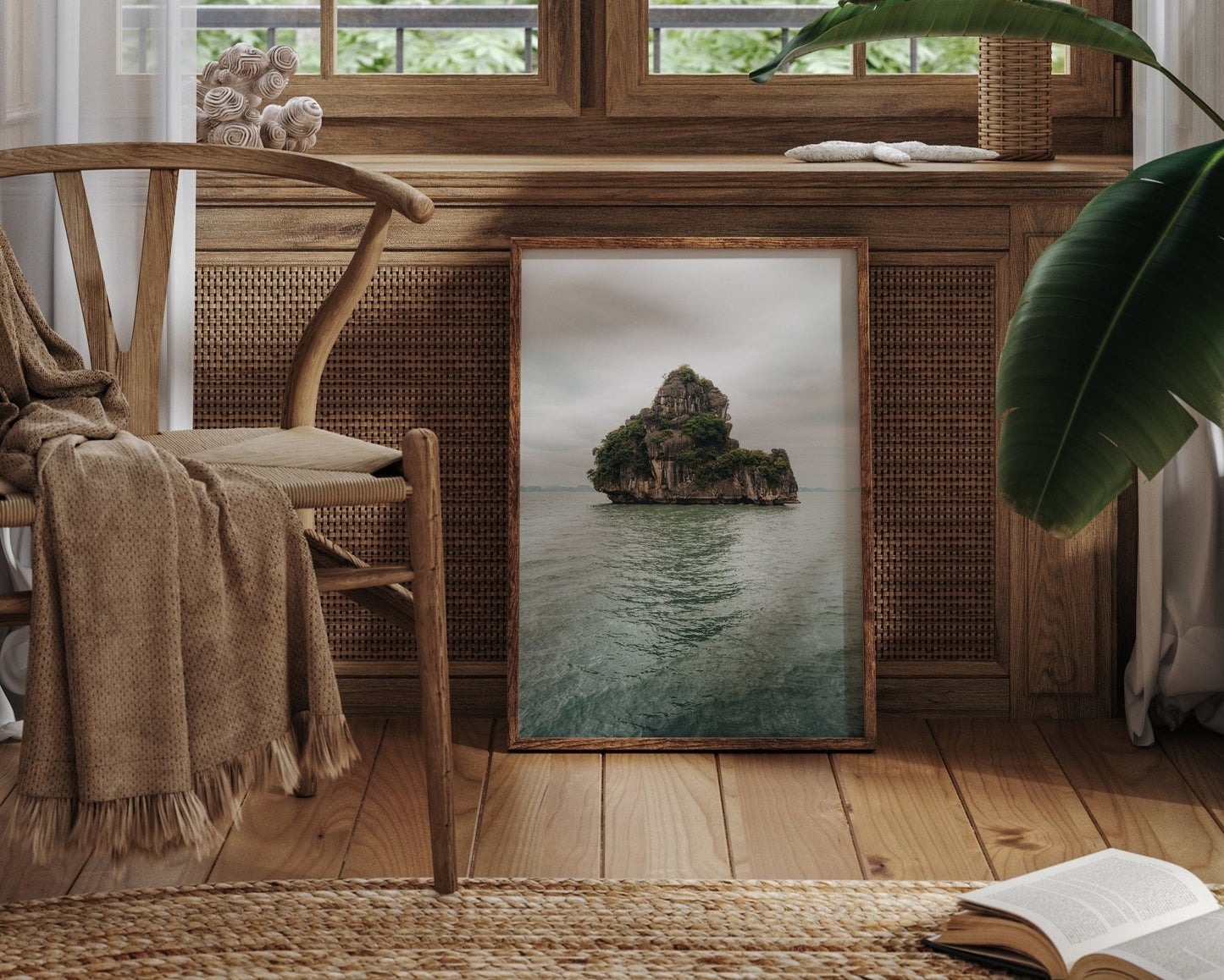 Cozy room with a framed seascape, chair, plant, book near a window, and Solo Limestone piece.