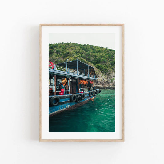 Framed Southeast Asia Boat photo of a boat on turquoise water with a forested island backdrop.