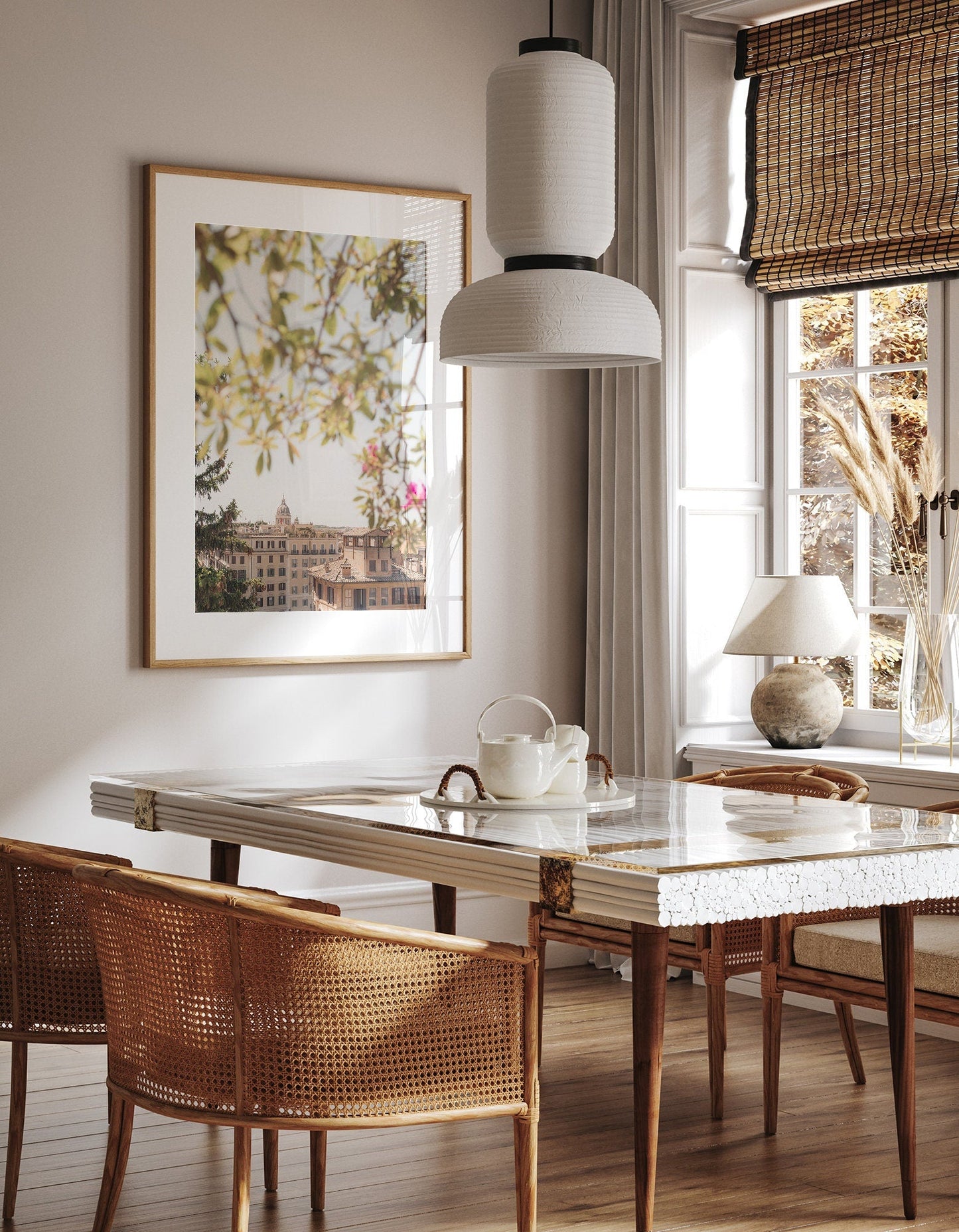 Bright dining room with the Spanish Steps View framed artwork near a window with bamboo blinds.