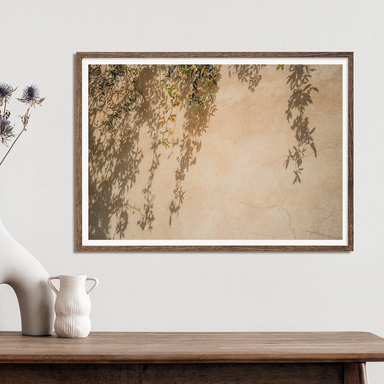 Spring Breeze: A framed photo of plant shadows with a flower vase on a wooden table.
