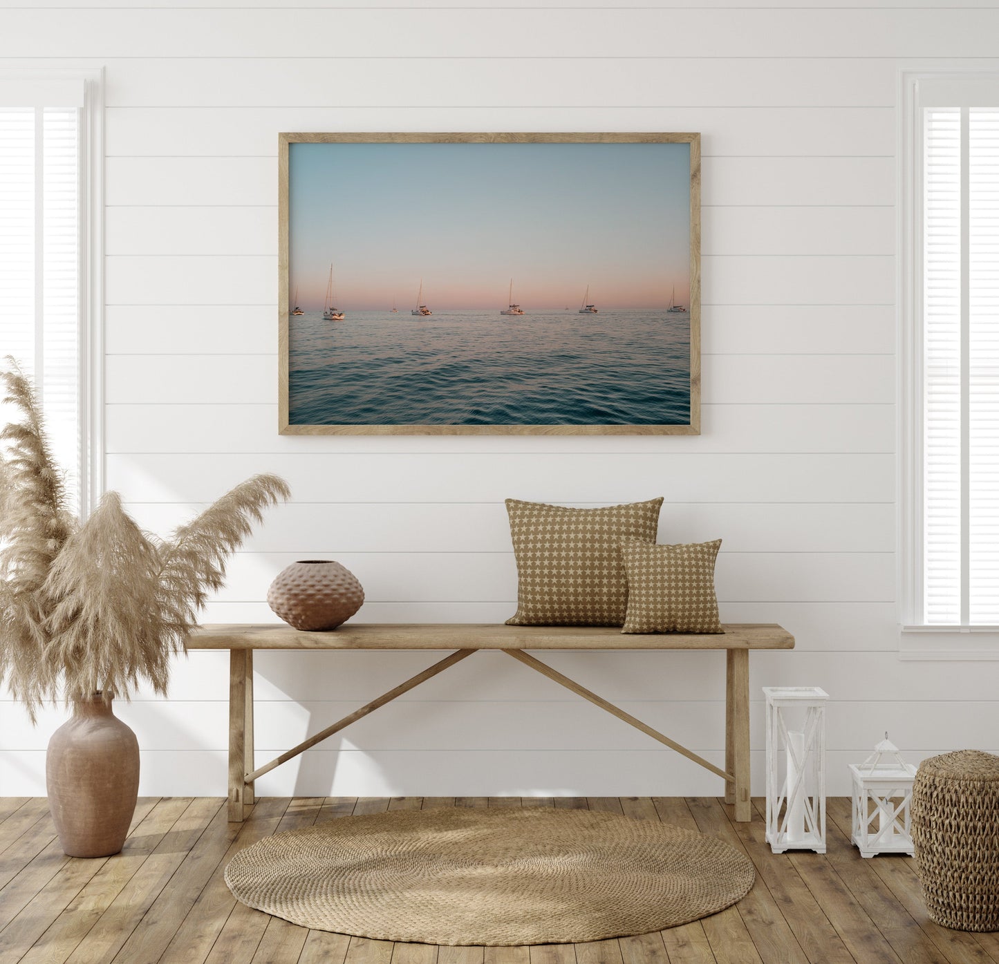 Cozy coastal-style room with a wooden bench, woven decor, and the Sunset Formation photo on the wall.