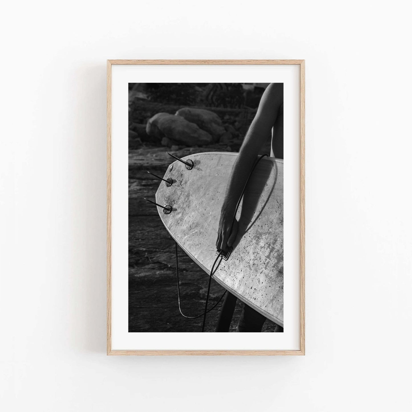 Surf Spirit Black and White photo of a person with a surfboard, framed on a wall.