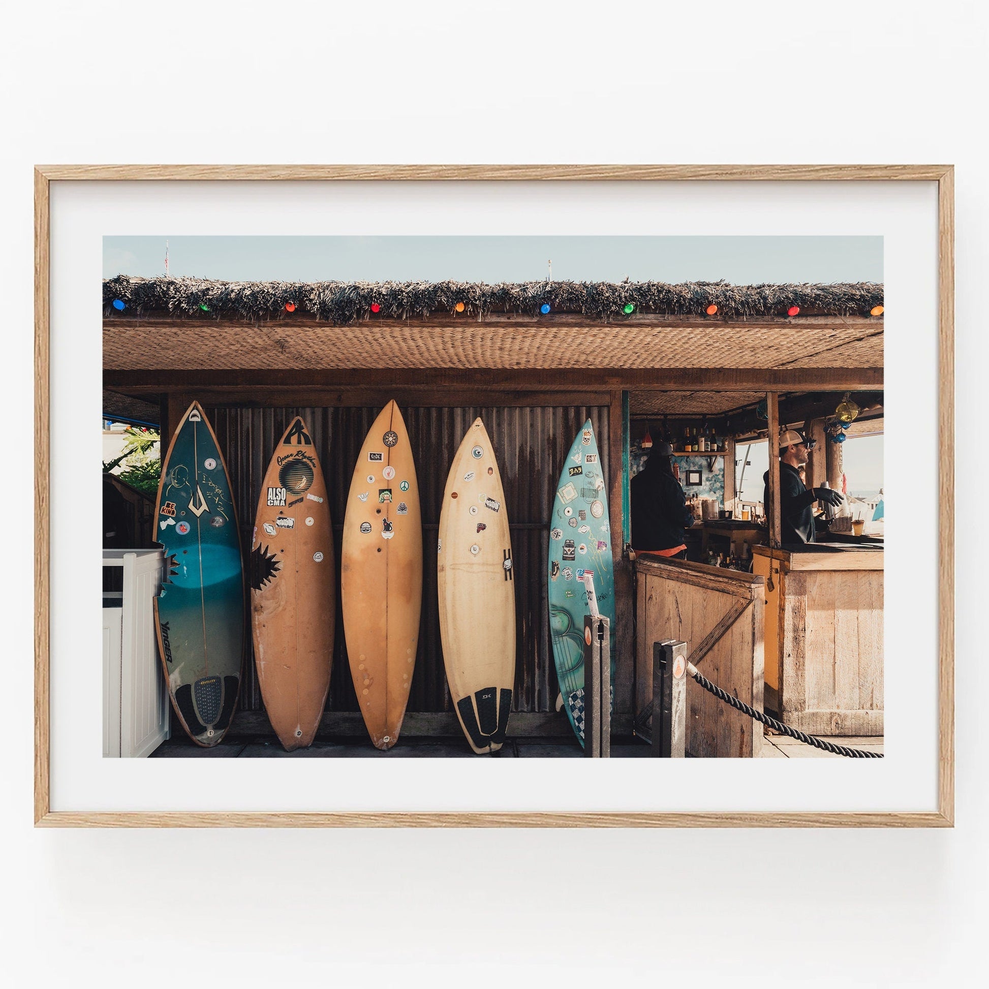 Framed Surfboard Cafe photo of four surfboards at a rustic beach shack with colorful roof lights.