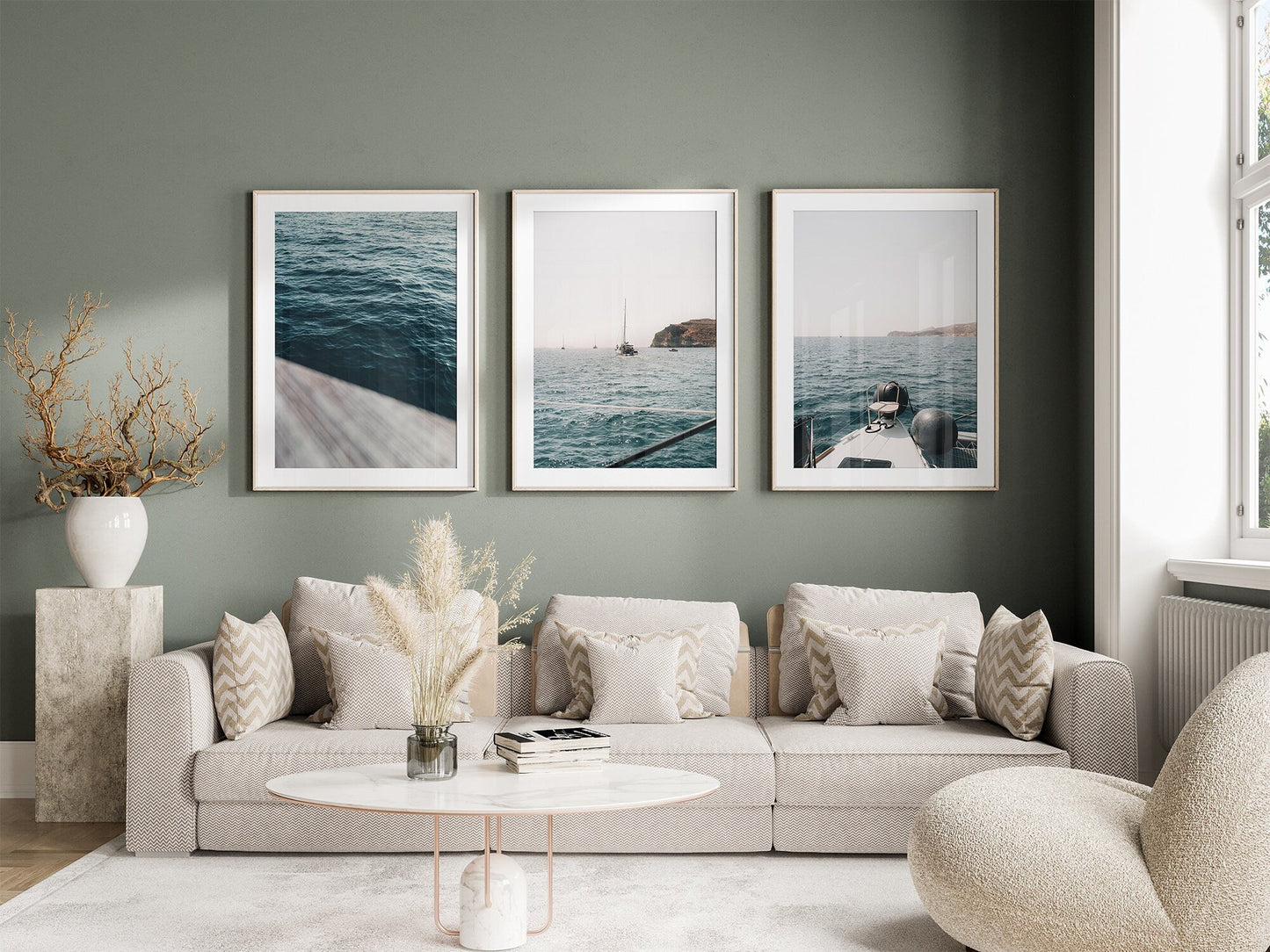 A cozy living room with a light gray sofa, decorative cushions, and the Teal Ocean - Set of 3 on a green wall.