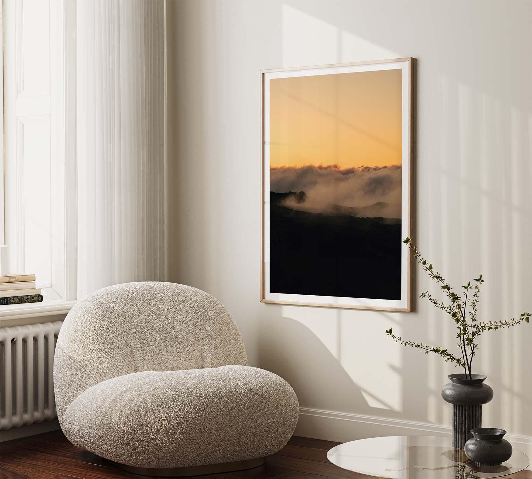 Teide Trance art hangs above a cozy armchair by the window, near a round table and plant.