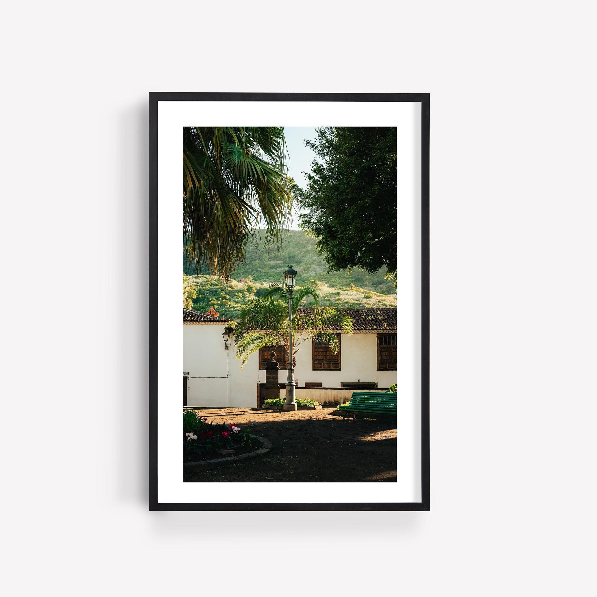 Framed photo titled "Tenerife Garden" shows a sunny courtyard with palm, lamppost, and white building by a green hillside.
