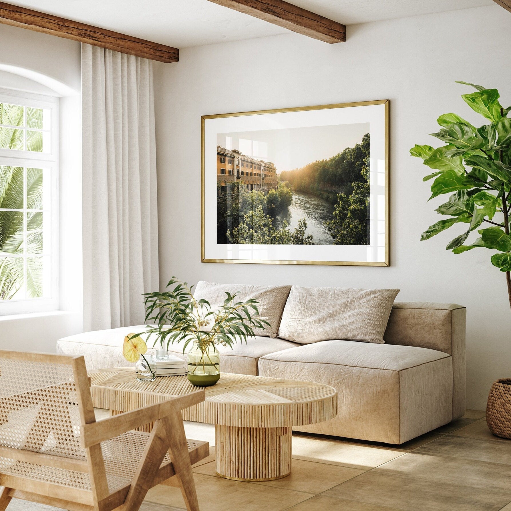 Minimalist living room with a beige sofa, wooden chair, plants, and Tiber Island Glow II painting on the wall.