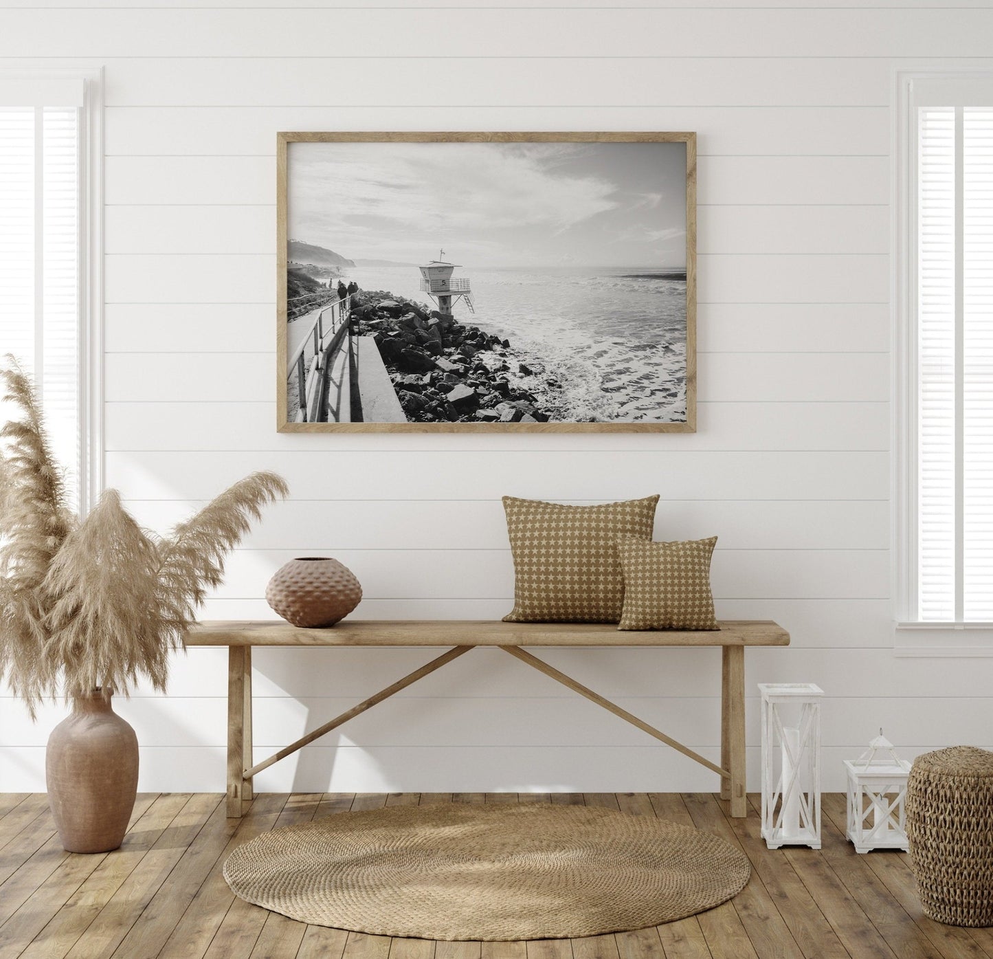 Minimalist interior with a wooden bench, pillows, and decor under Torrey Pines Black and White. Neutral tones and woven rug.