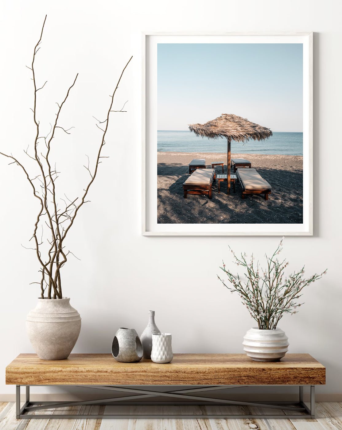 Tranquil Shade framed photo above a wooden bench with vases and branches in a minimalist room.