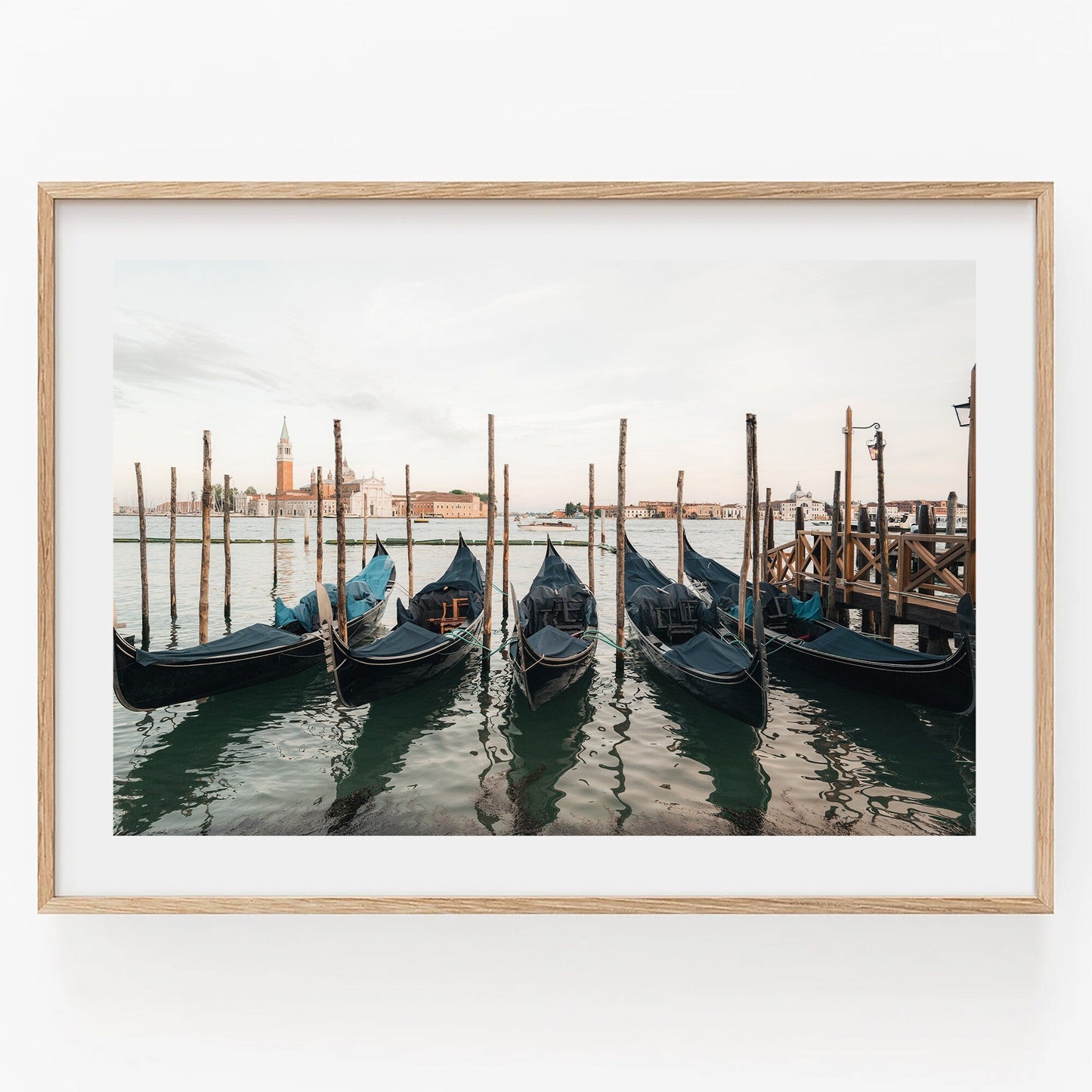 Venetian Array: Framed photo featuring docked gondolas on a calm Venetian waterway with historic buildings in the background.