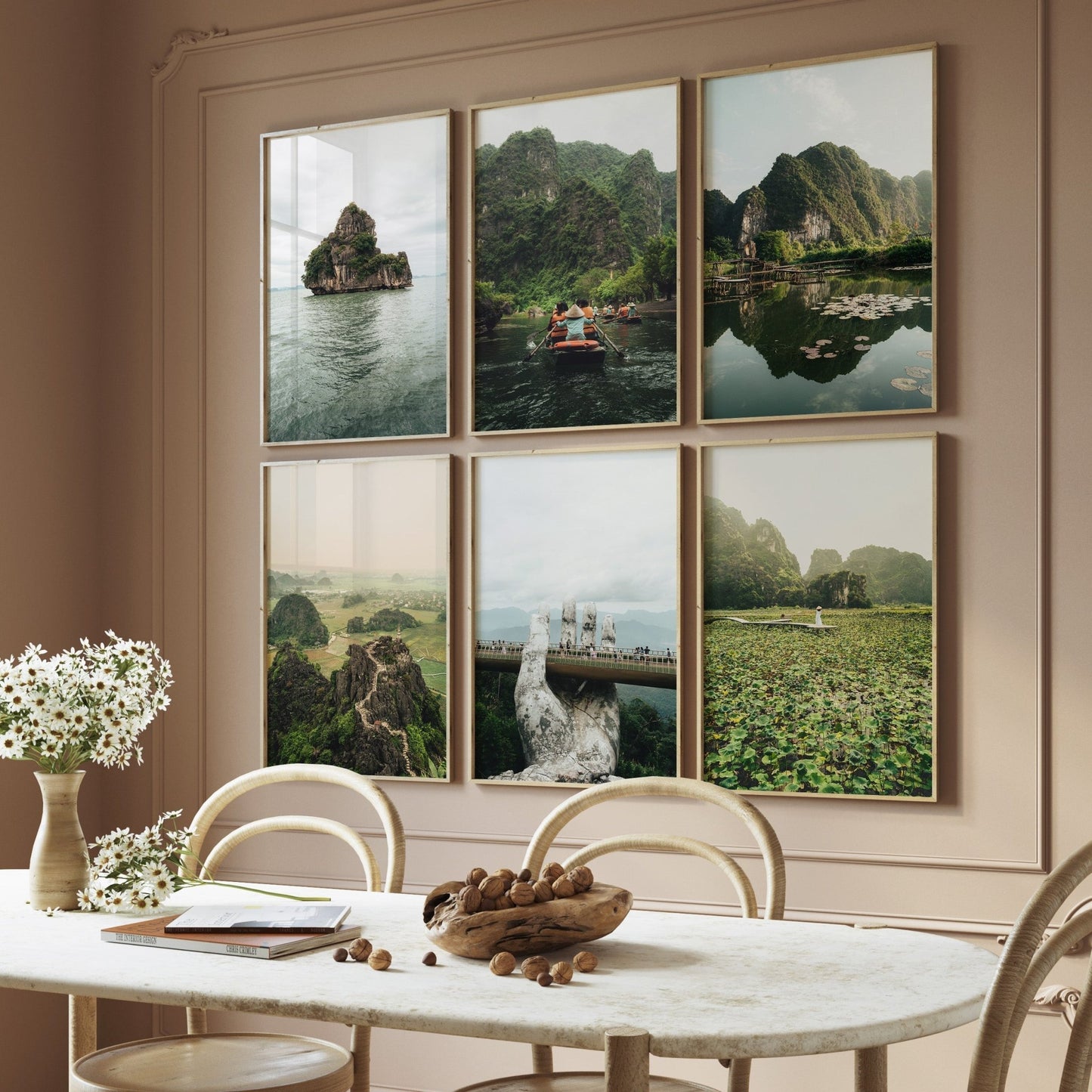 Dining area with a table, chairs, a vase of white flowers, and the Vietnam Nature - Set of 6 landscape photos on the wall.