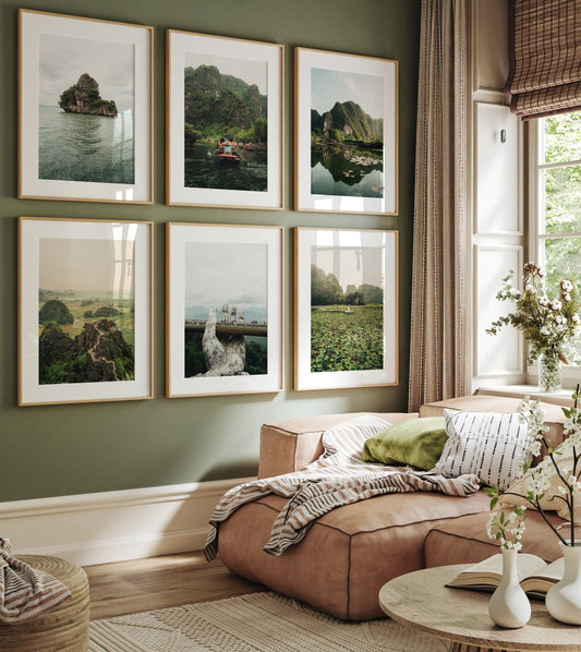 A cozy living room with a beige couch and green cushions, featuring Vietnam Nature set on a green wall. Bright window light.